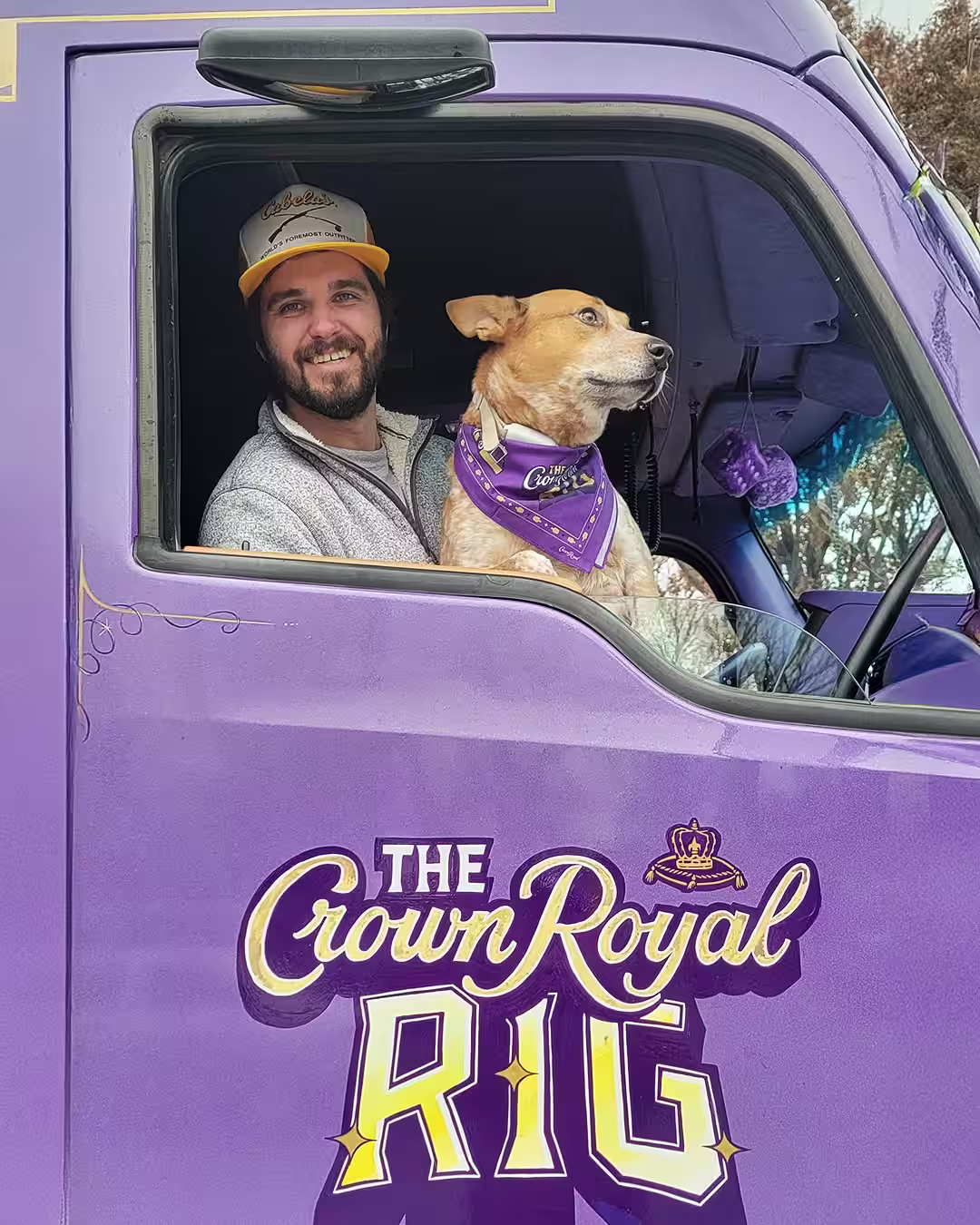 A person sitting in the Crown Royal Rig with a dog