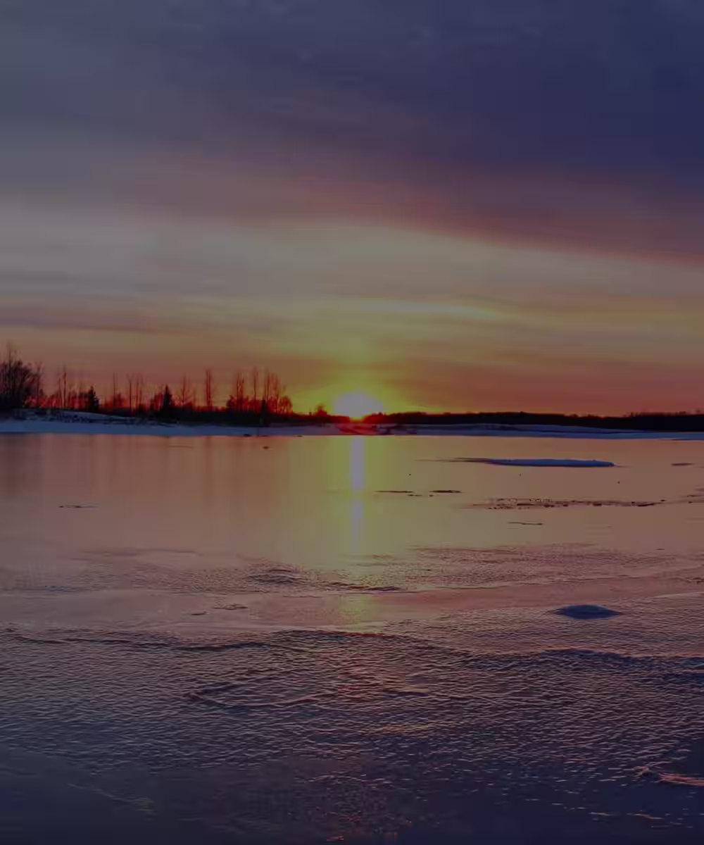 The sun setting over a frozen lake