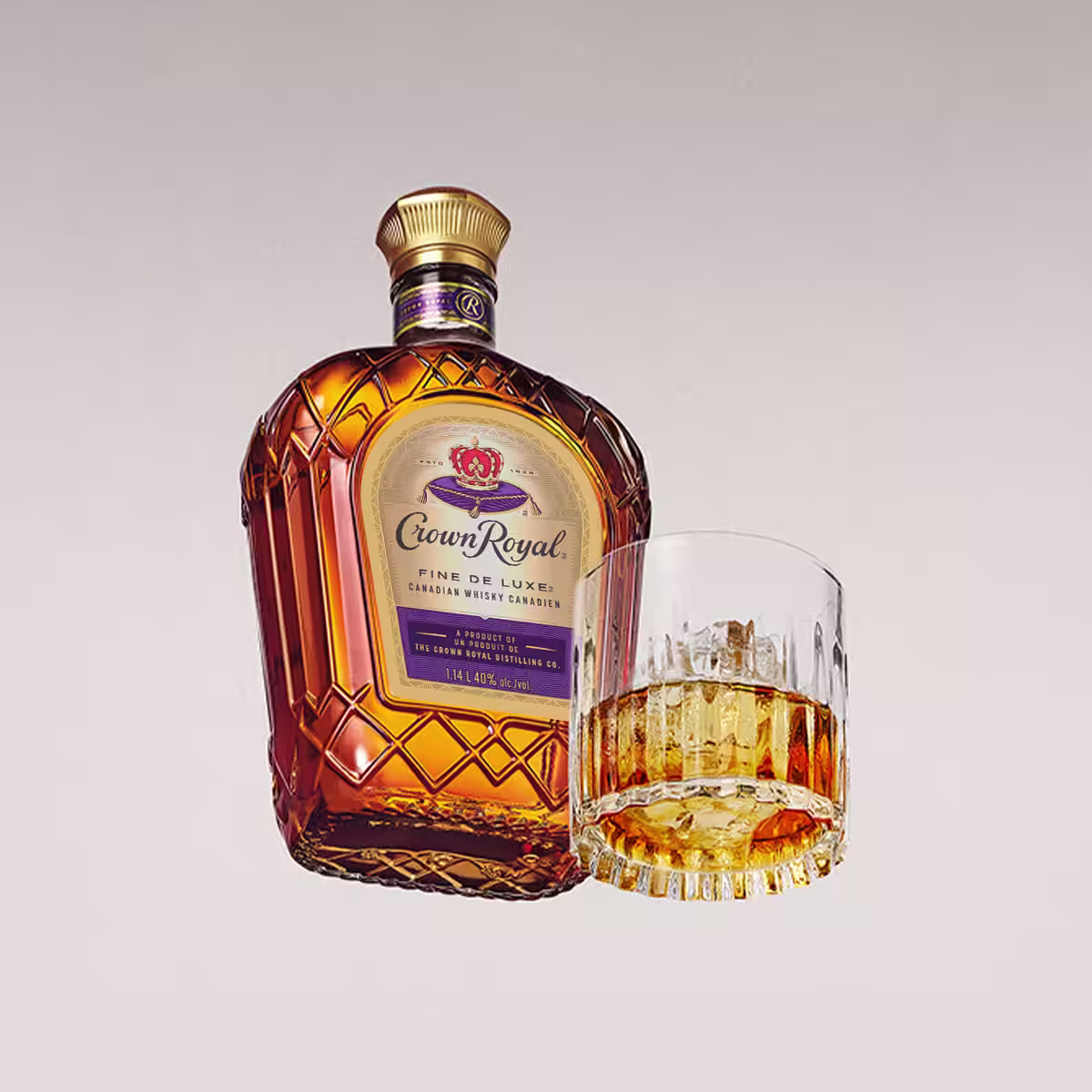 A bottle of Crown Royal Fine De Luxe next to a glass