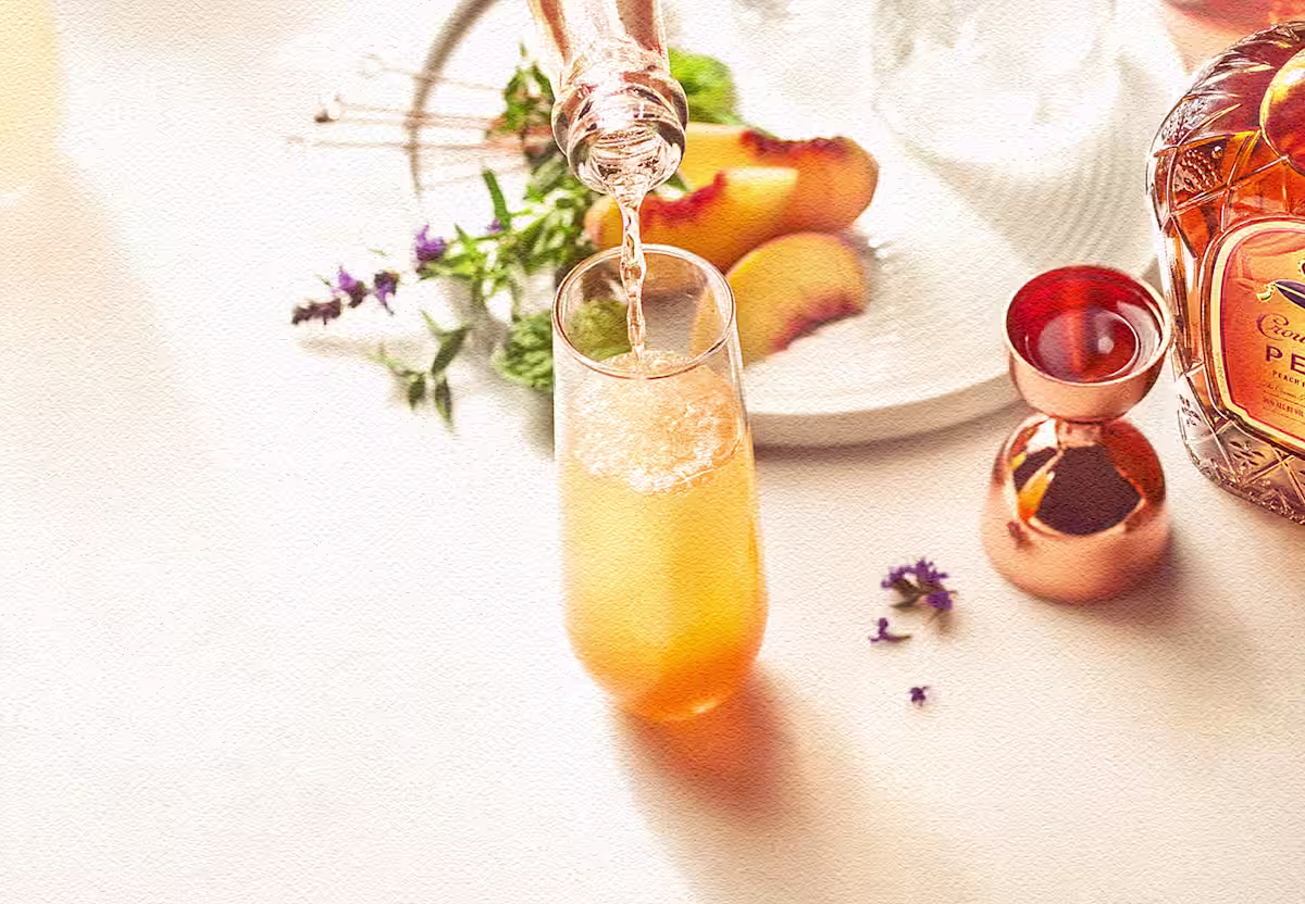 Enjoy a Royal Peach Fizz cocktail with Crown Royal Peach, orange juice, a splash of champagne to top it off and a fresh mint garnish.