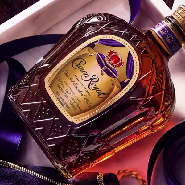 A bottle of Crown Royal Fine De Luxe laying on a table