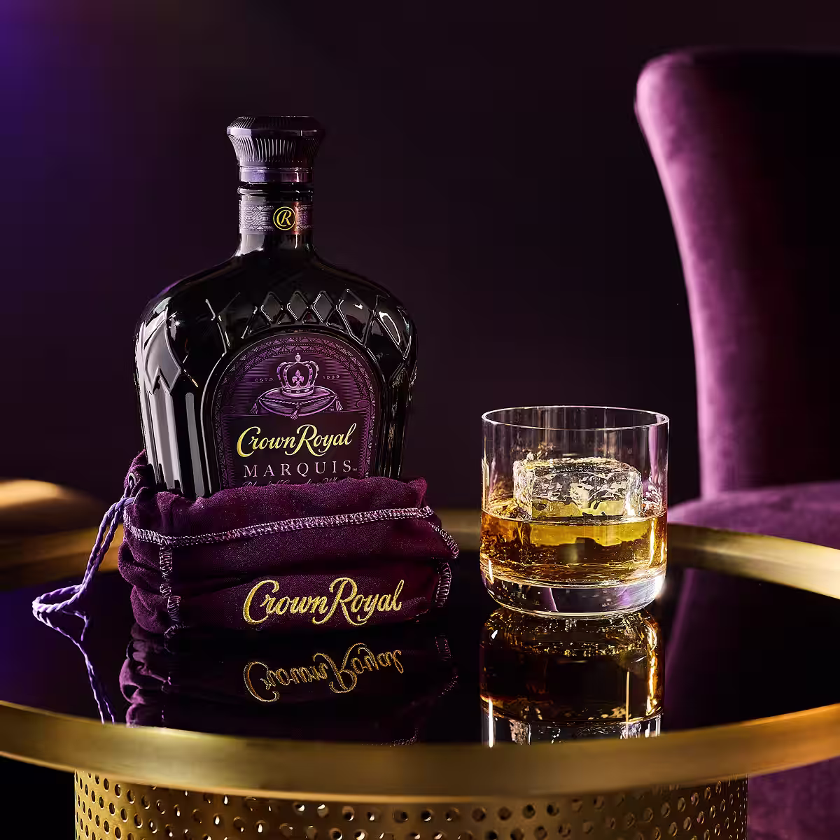 Crown Royal Marquis bottle with cocktail on table.