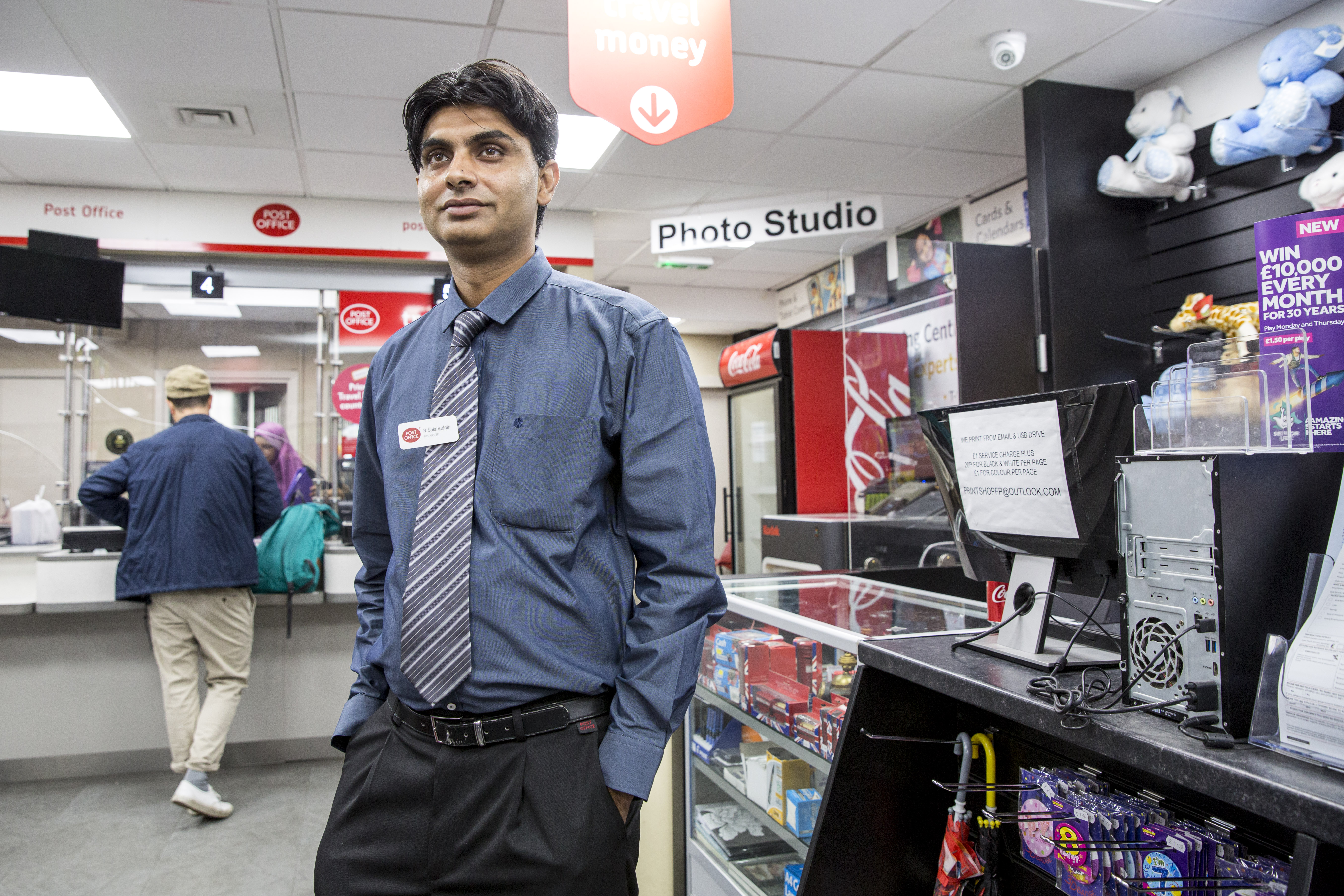 A photograph of Rizwan Salahuddin standing inside Finsbury Park Post Office
