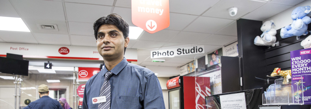 A photograph of Rizwan Salahuddin standing inside Finsbury Park Post Office