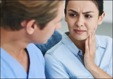 Patient discussing tooth sensitivity with a clinician