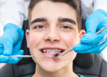 Pediatric orthodontic patient with dental tools