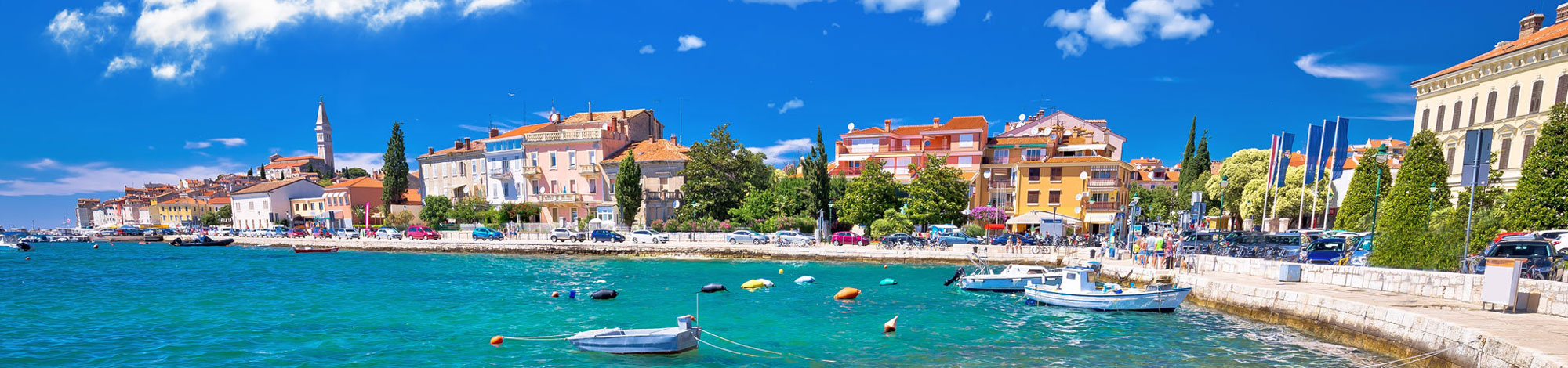 Bunte Häuserkulisse und kleine Bucht mit Booten