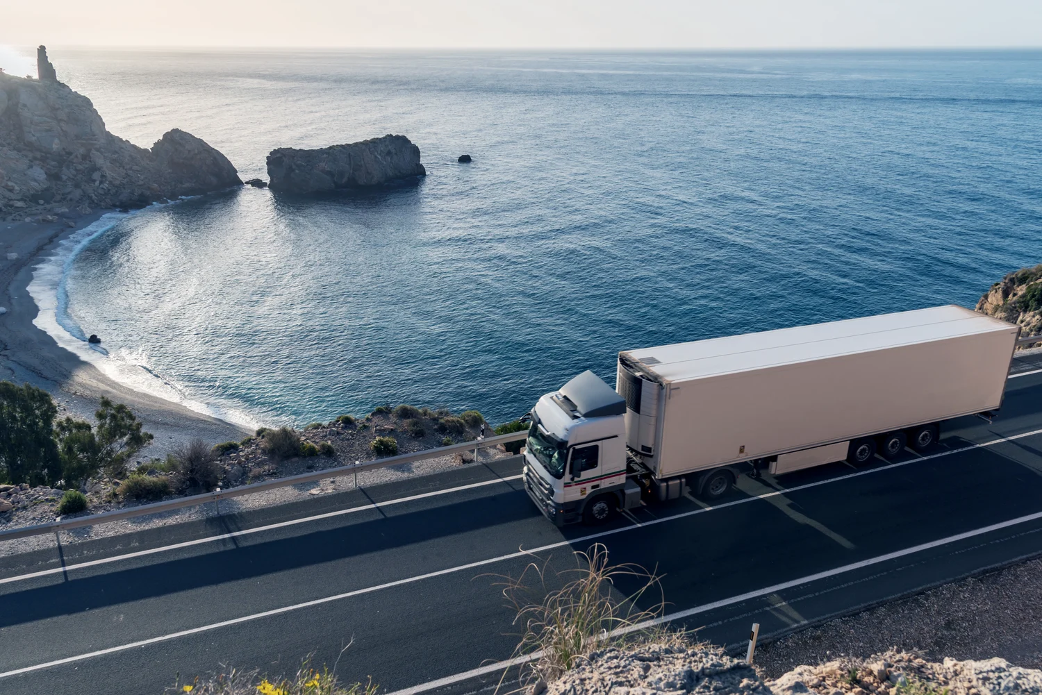 Sea view and a truck driving on the road