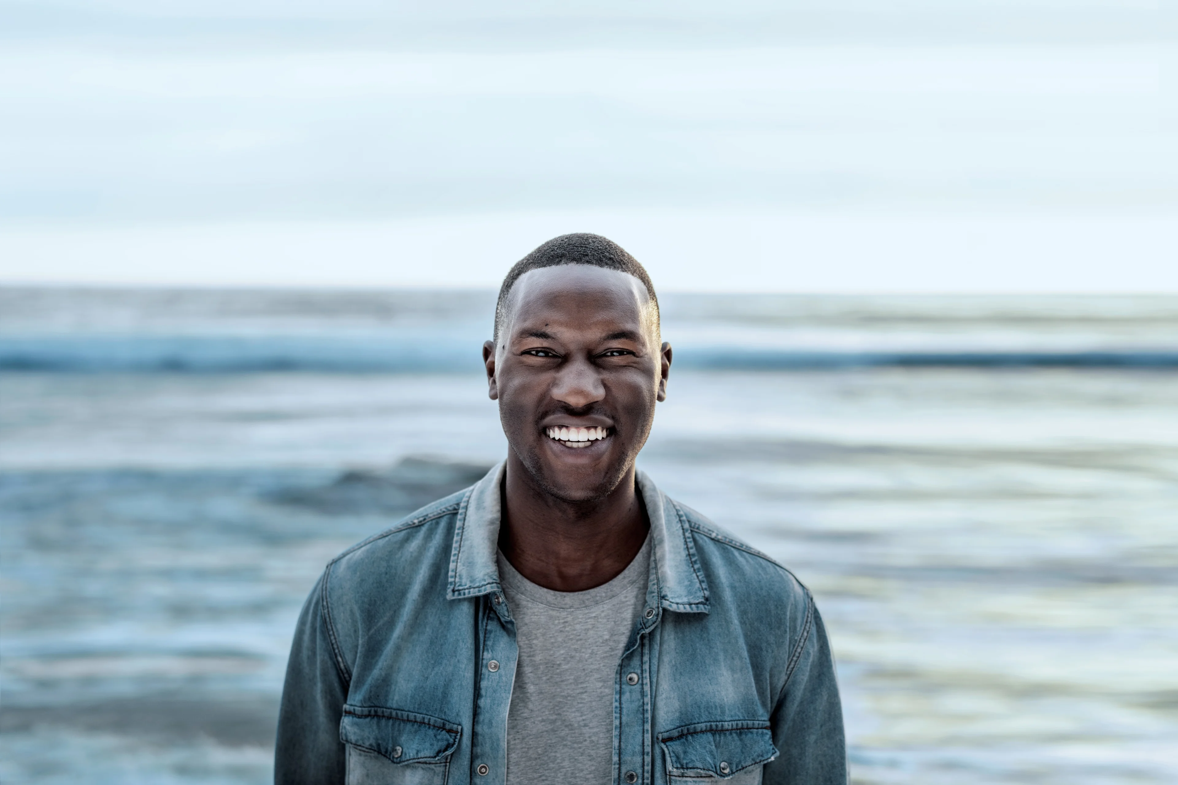 Man smiling by the ocean