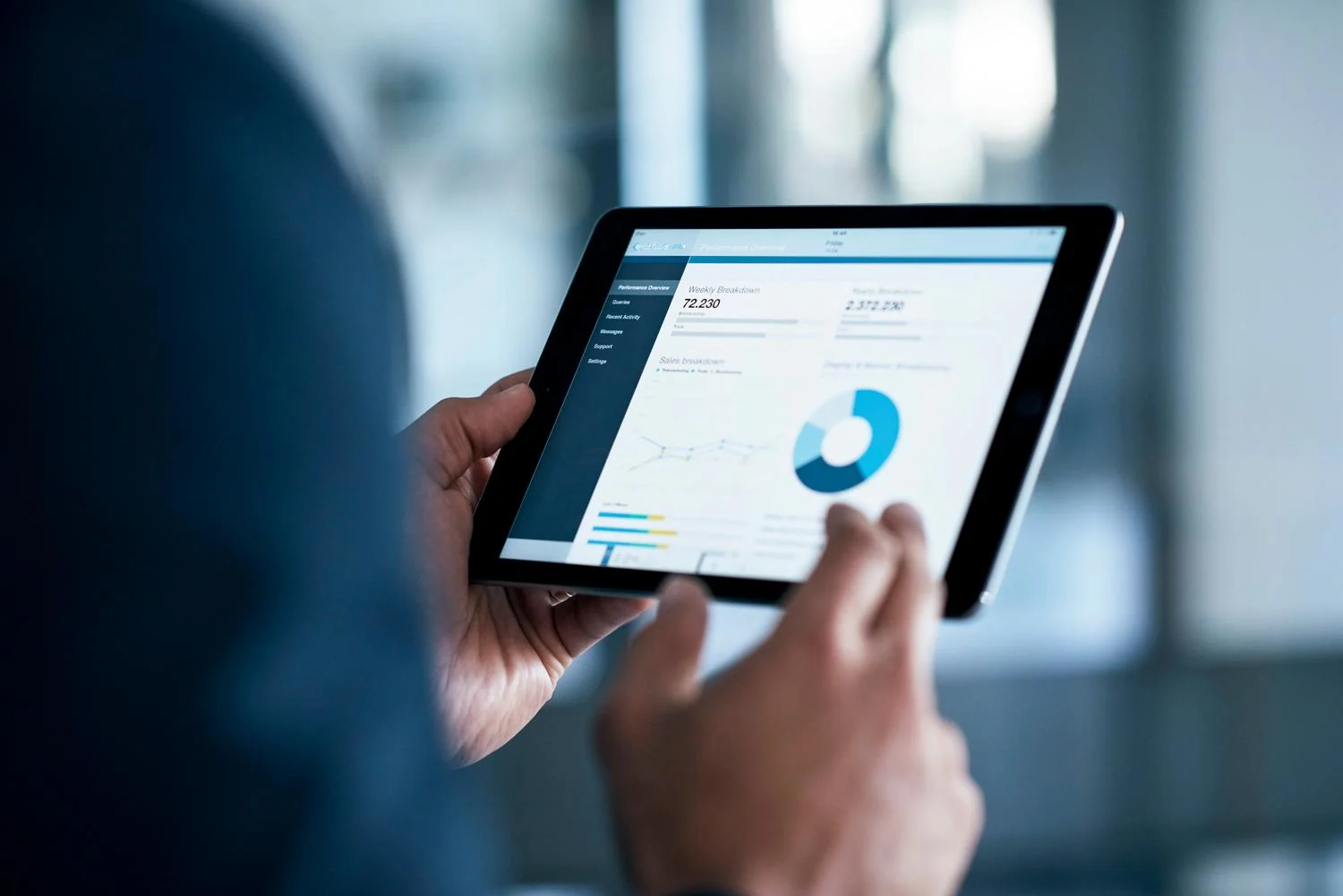 Analyzing market data on digital tablet | Neste