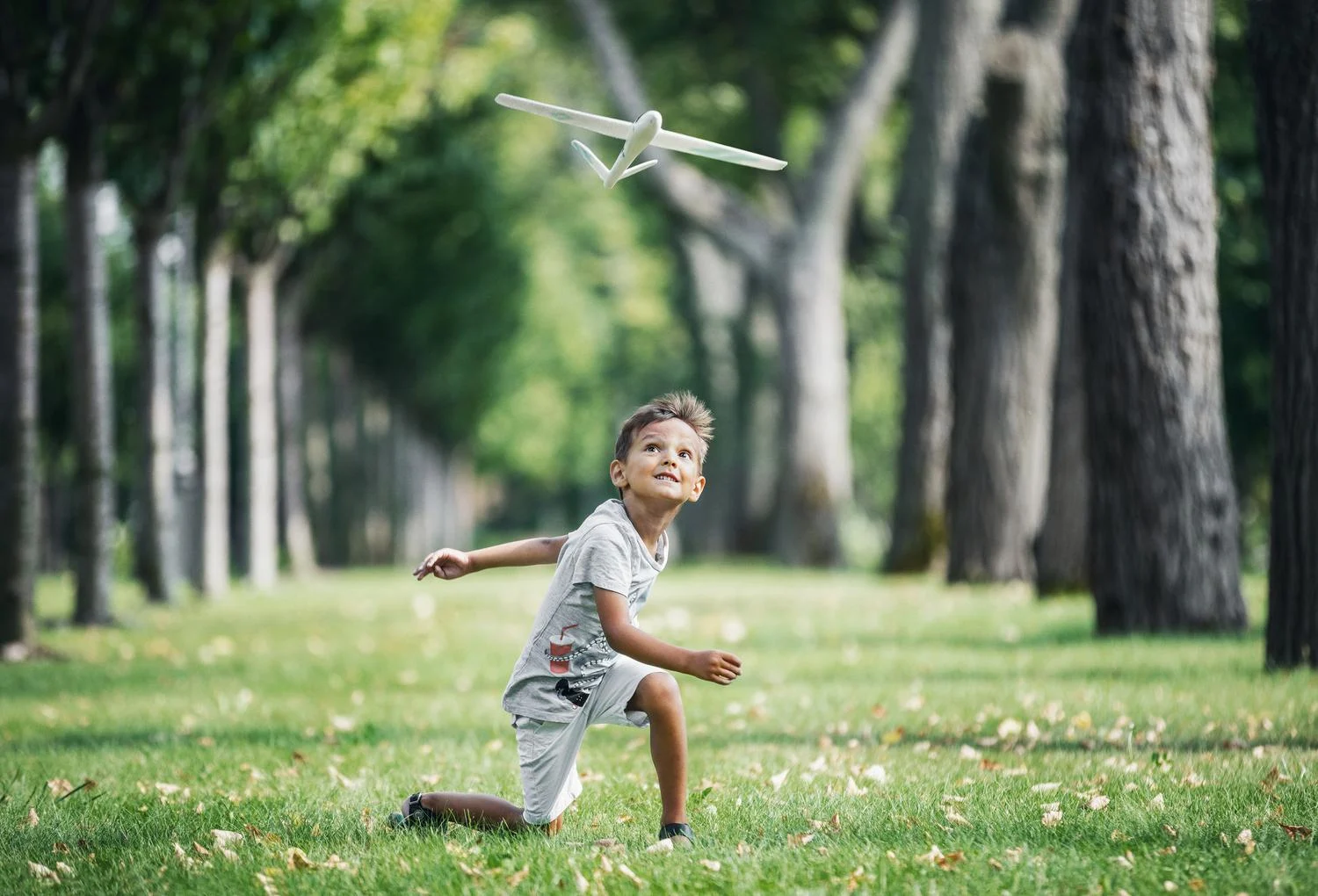 Boy running with airplane