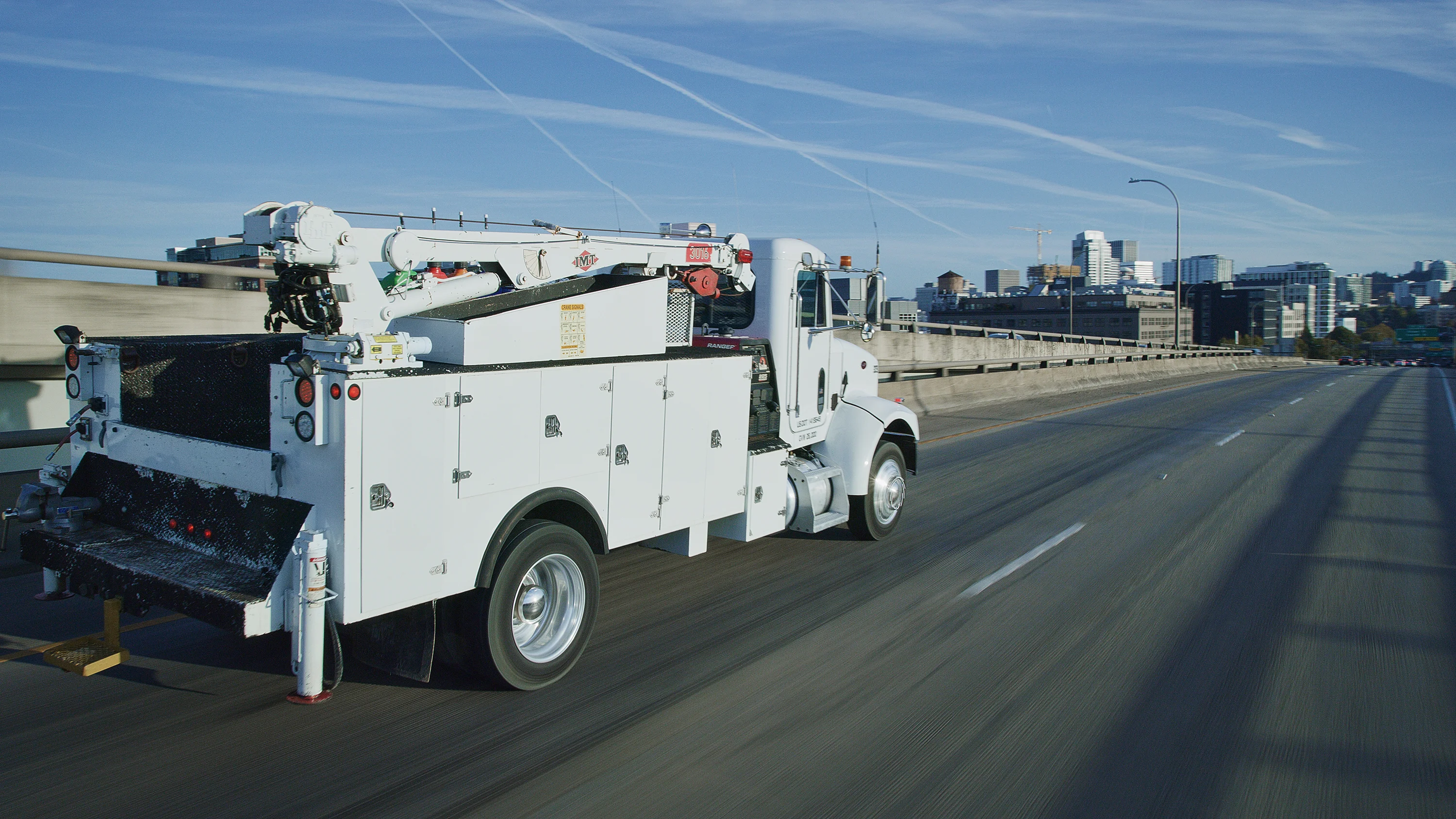 White utility truck on a road