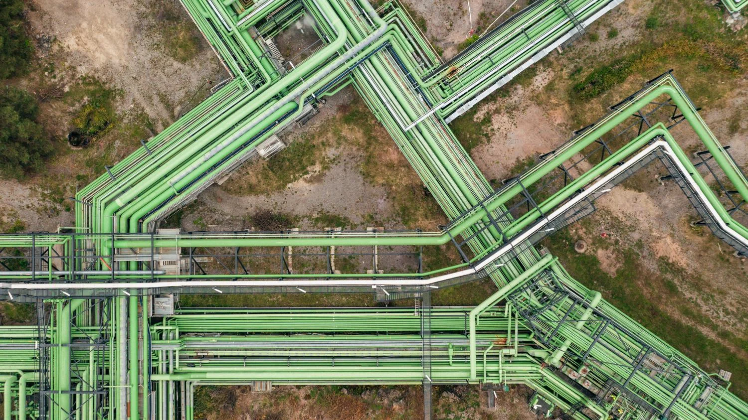 Aerial image of green refinery pipes. 
