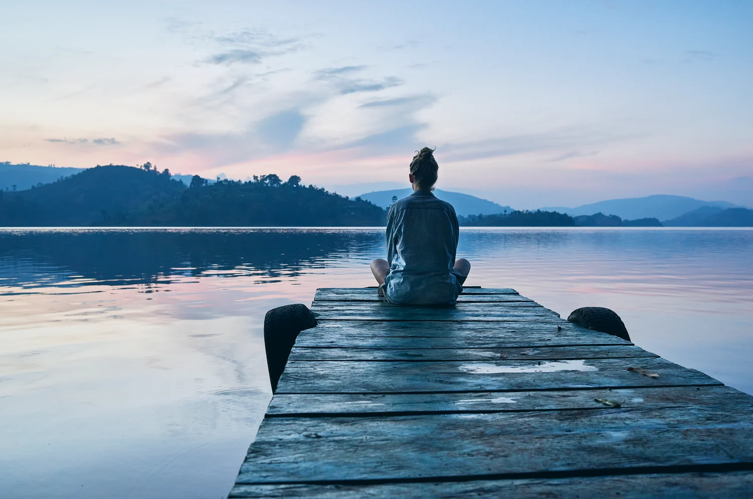 Woman sitting by the water