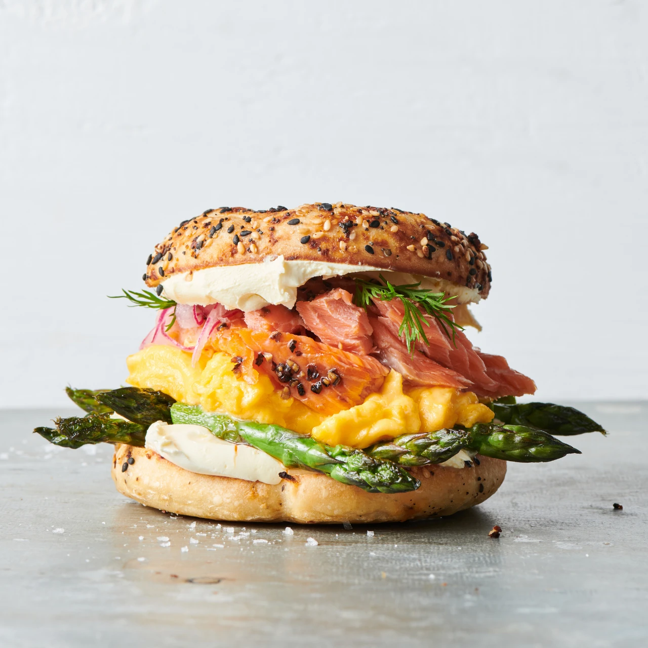 Loaded Smoked Salmon Bagel Recipe With Sanford and Sons Hot Smoked Salmon, Creamy Eggs, Aspargus and Rocket.