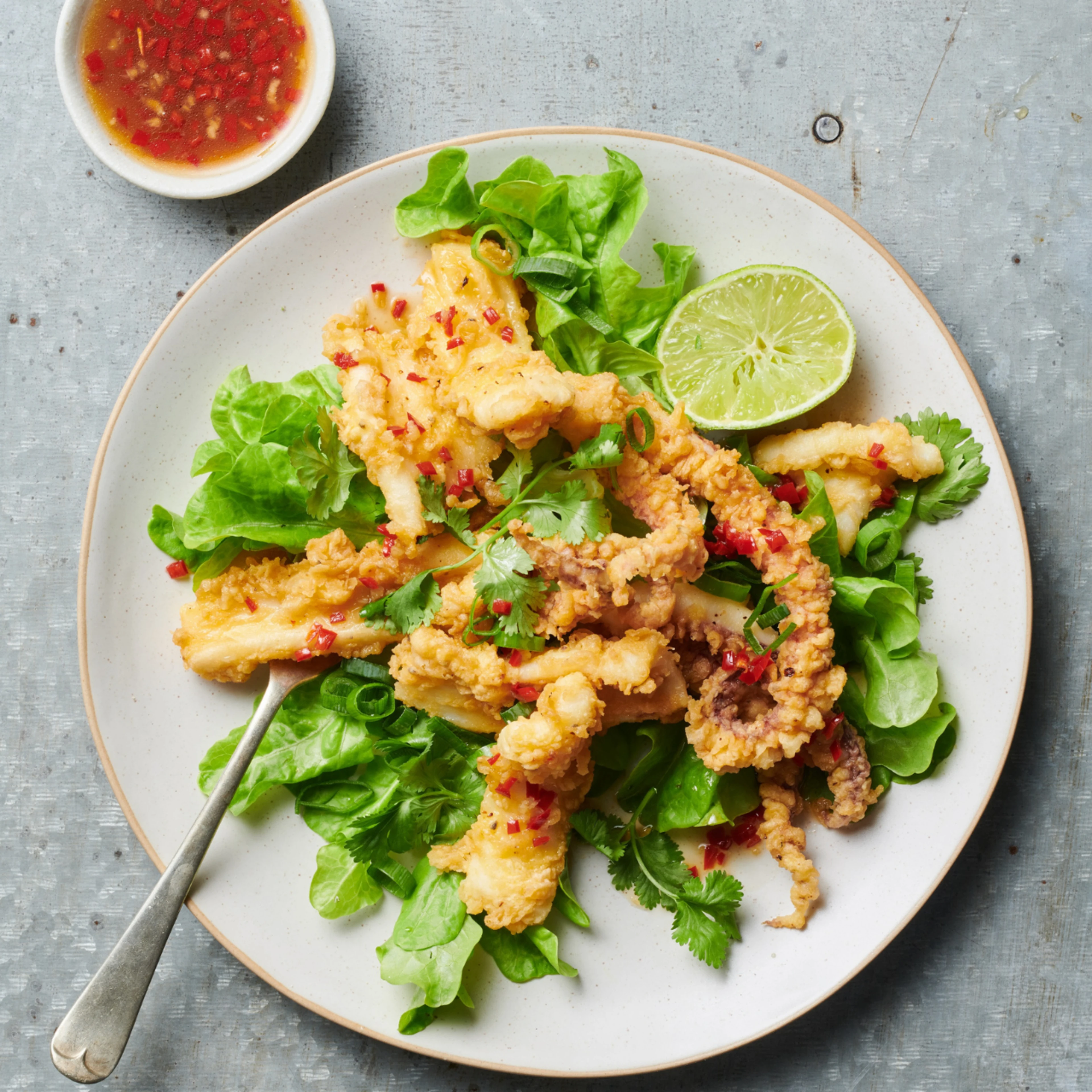 Crispy squid calamari salad with lime, chilli and honey dressing recipe. An easy meal for lunch or dinner.
