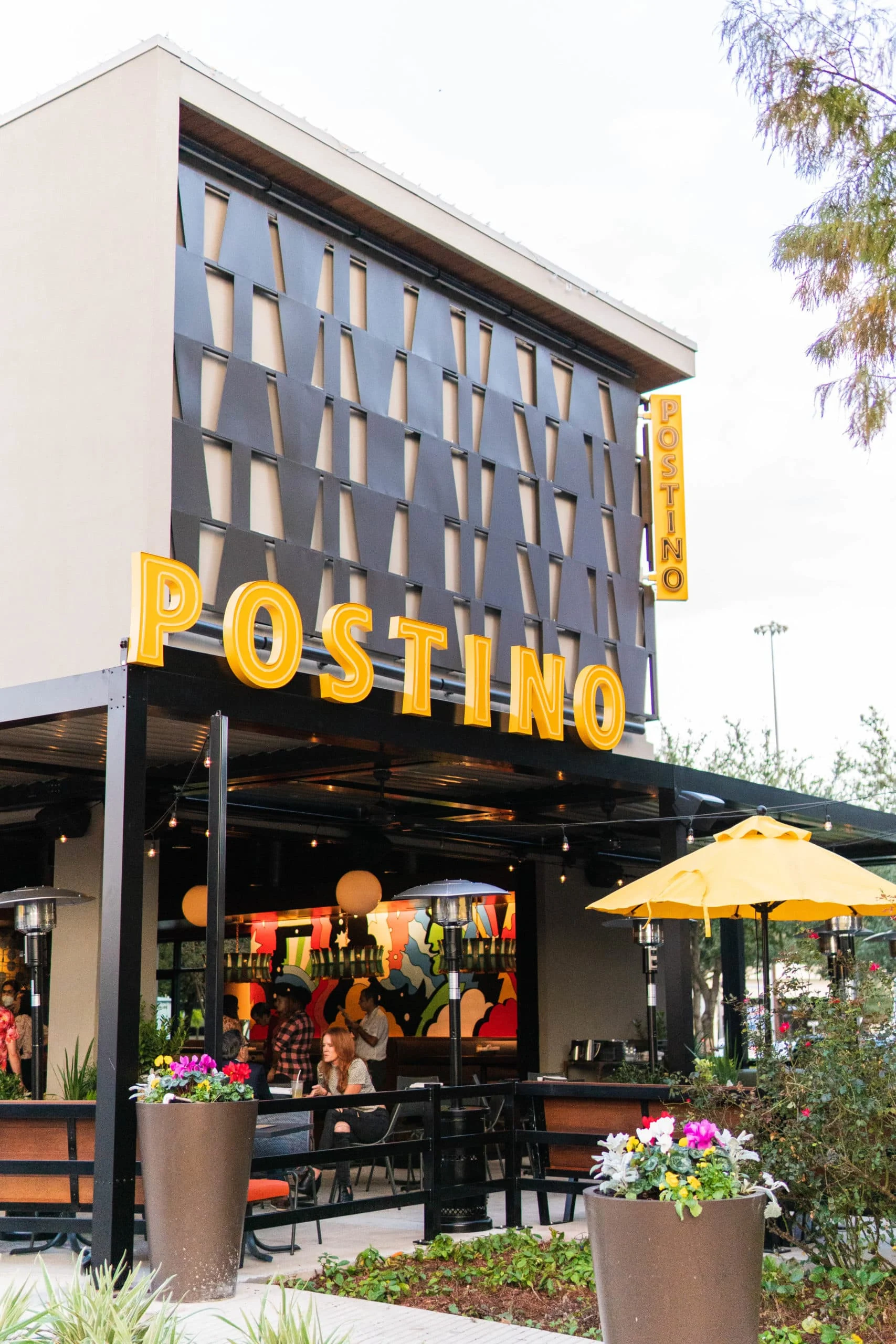 Building with large yellow Postino sign.