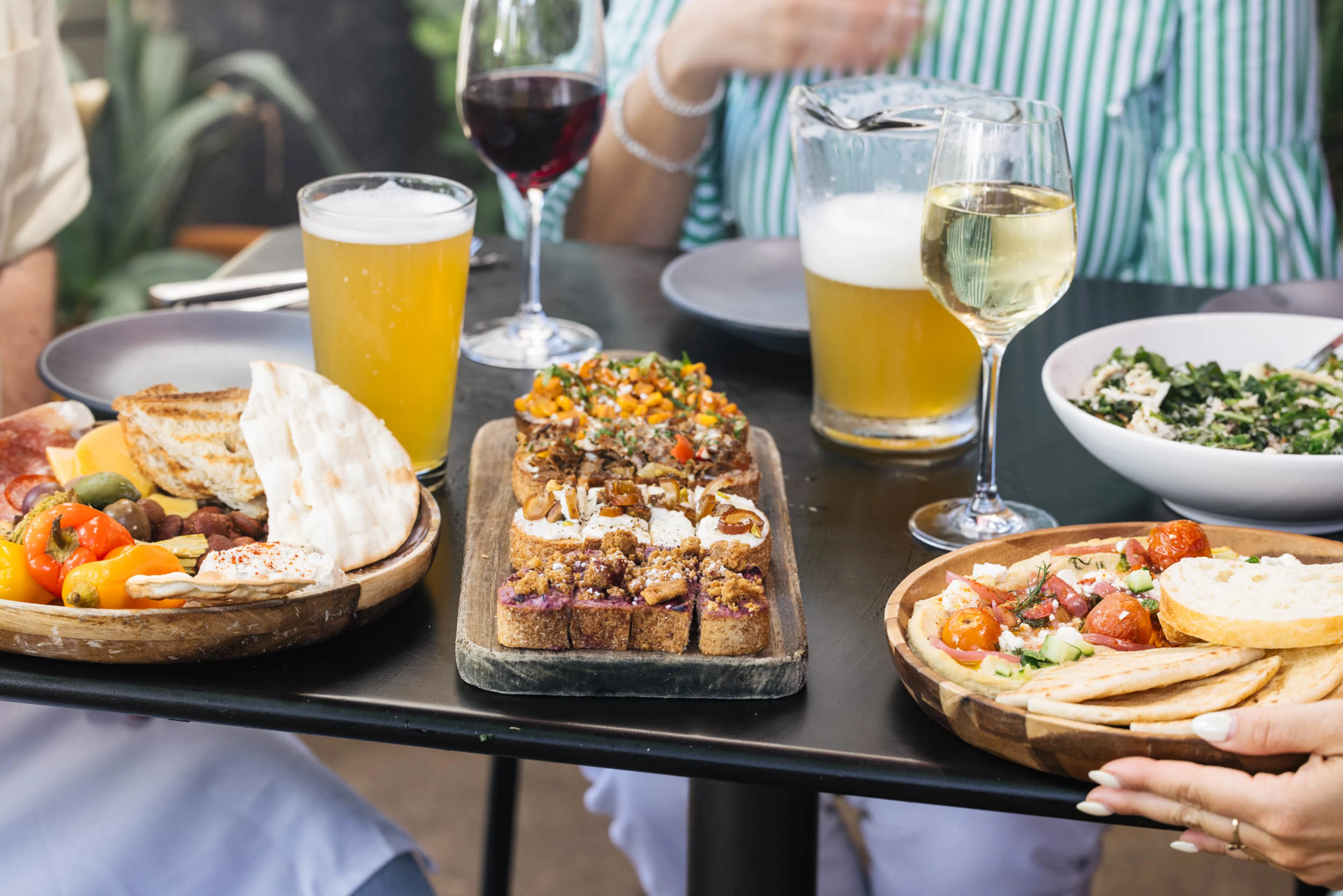 Close up shot of full table with food and drinks at a Postino