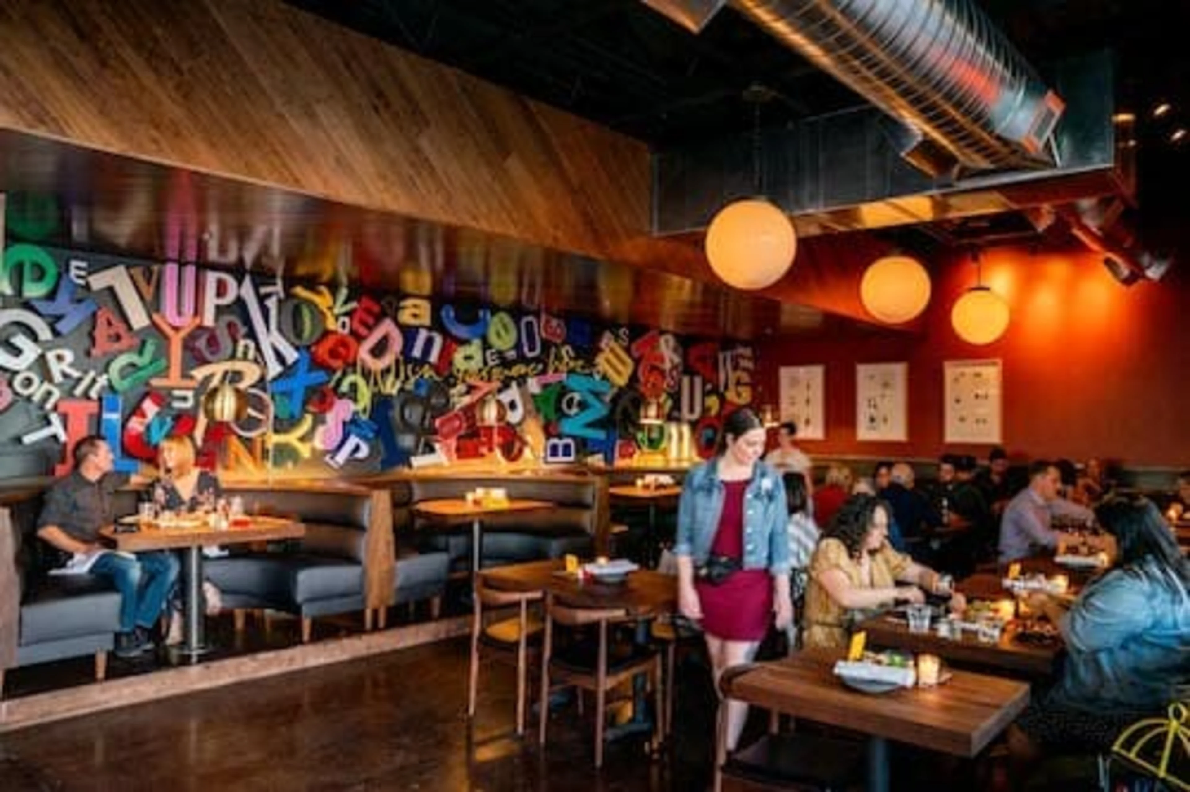 A restaurant with colorful walls and wooden tables.