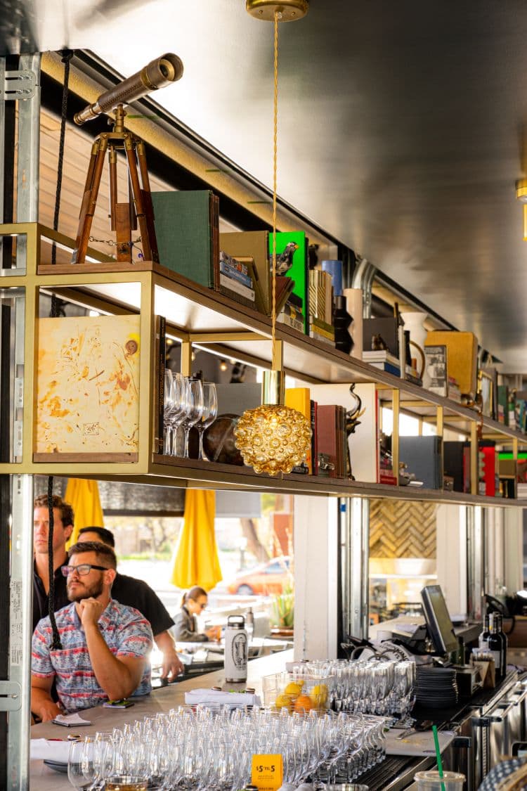 A restaurant bar with customers and glassware.