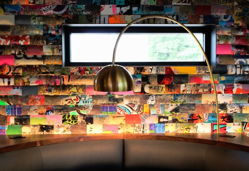 A colorful wall above a booth