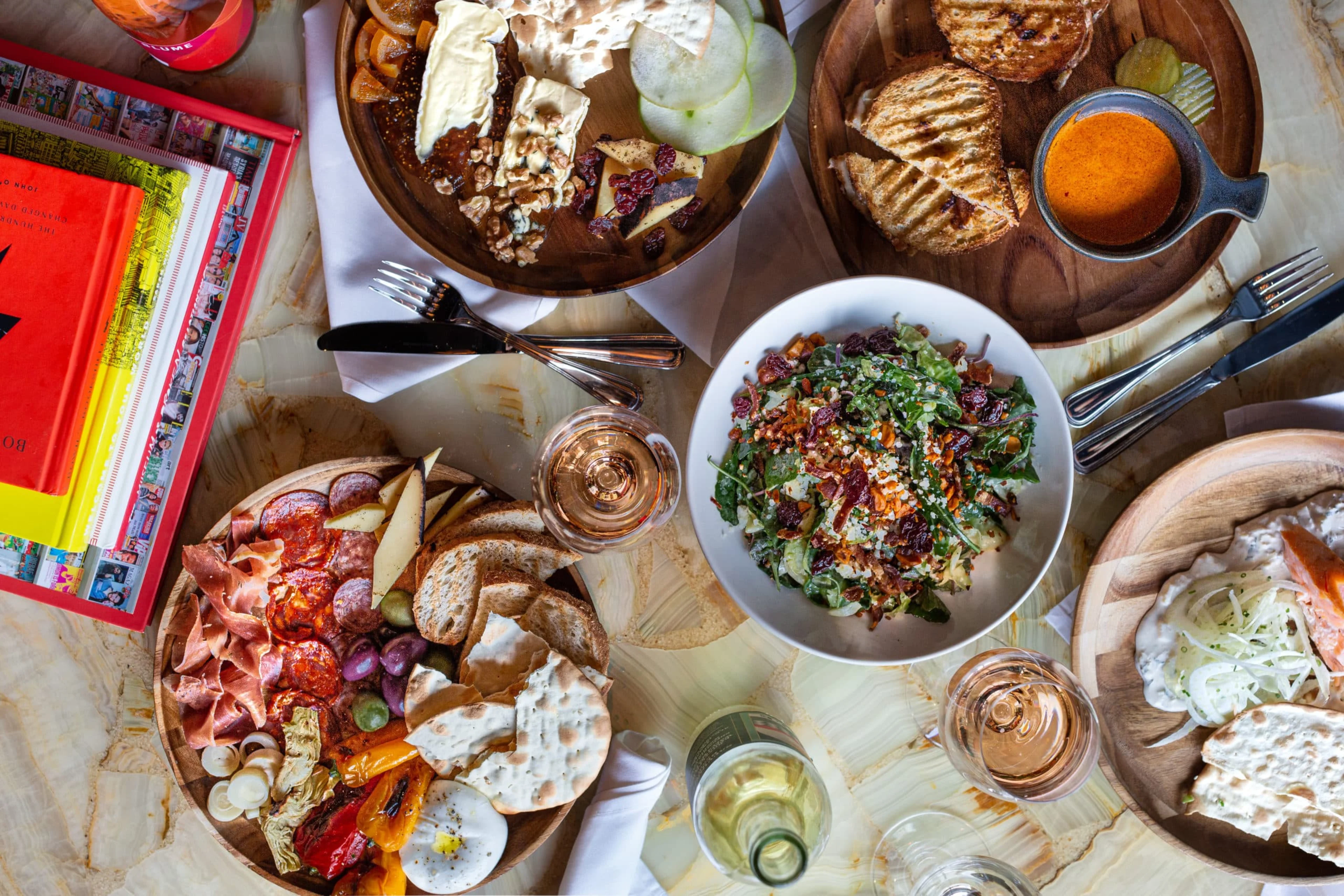A table full of food and magazines.