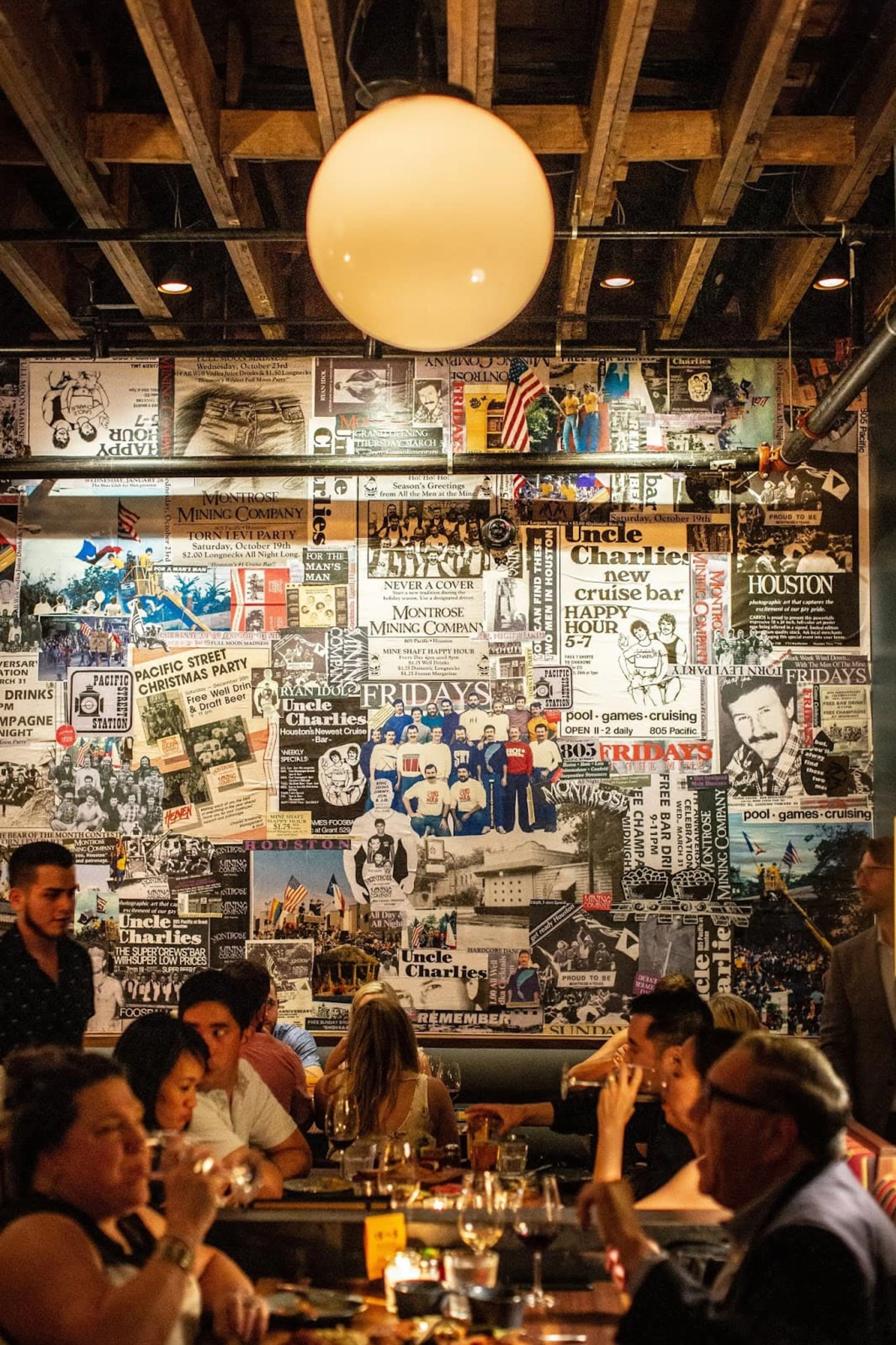 A busy restaurant with a collage art wall