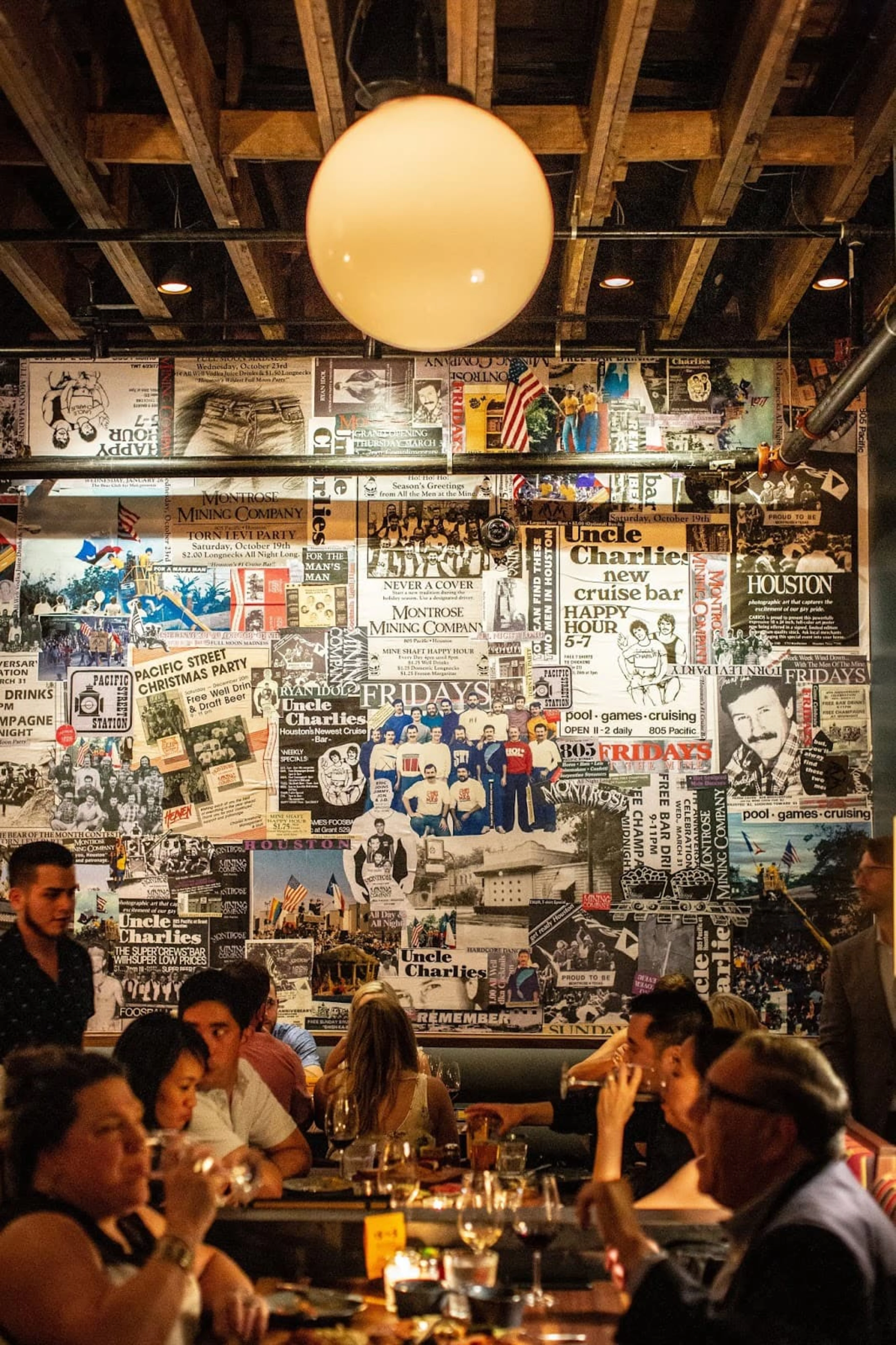 A busy restaurant with a collage art wall
