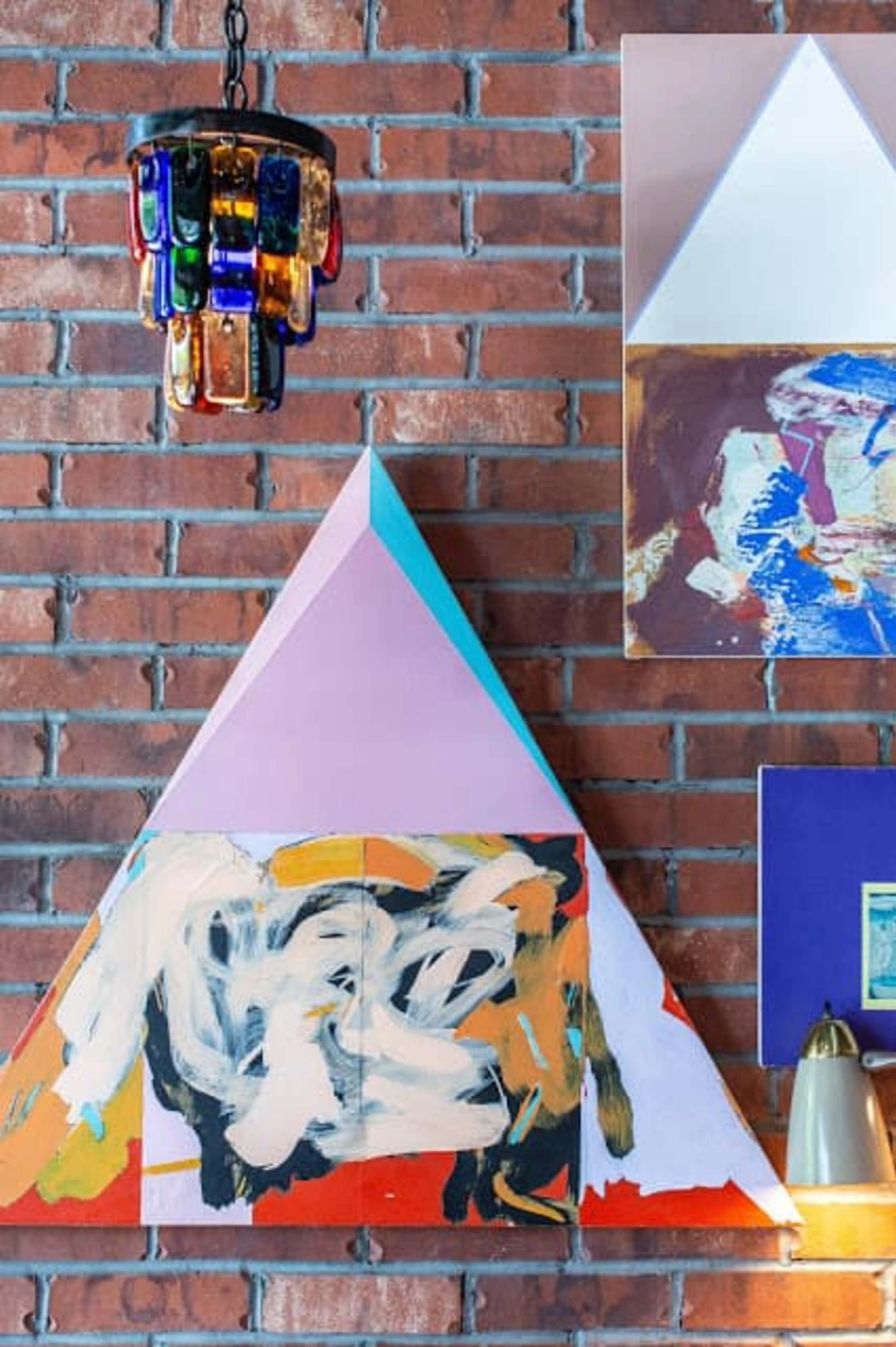 A brick wall with colorful pieces of art