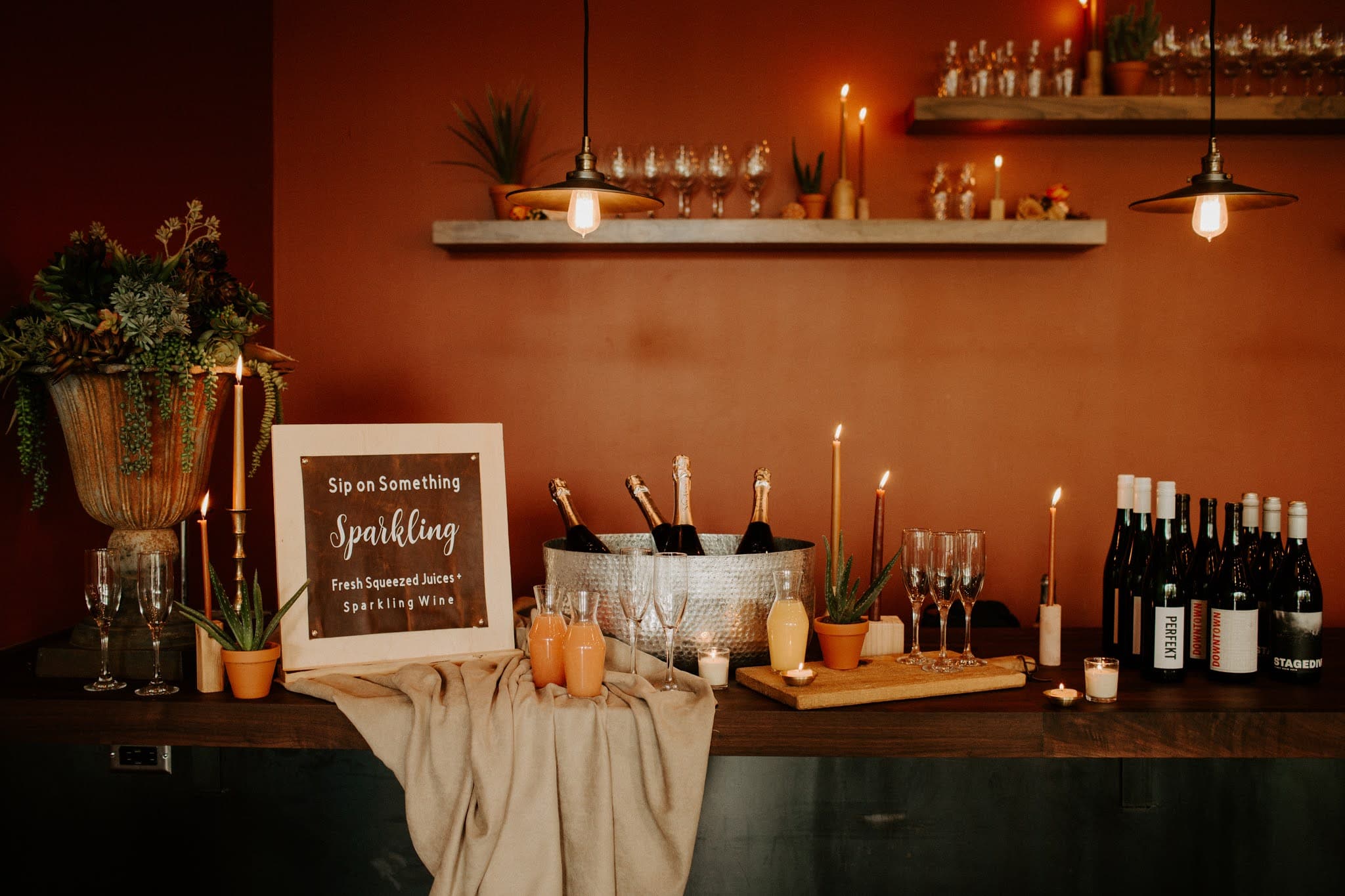 A table set for a wedding with a wine bar