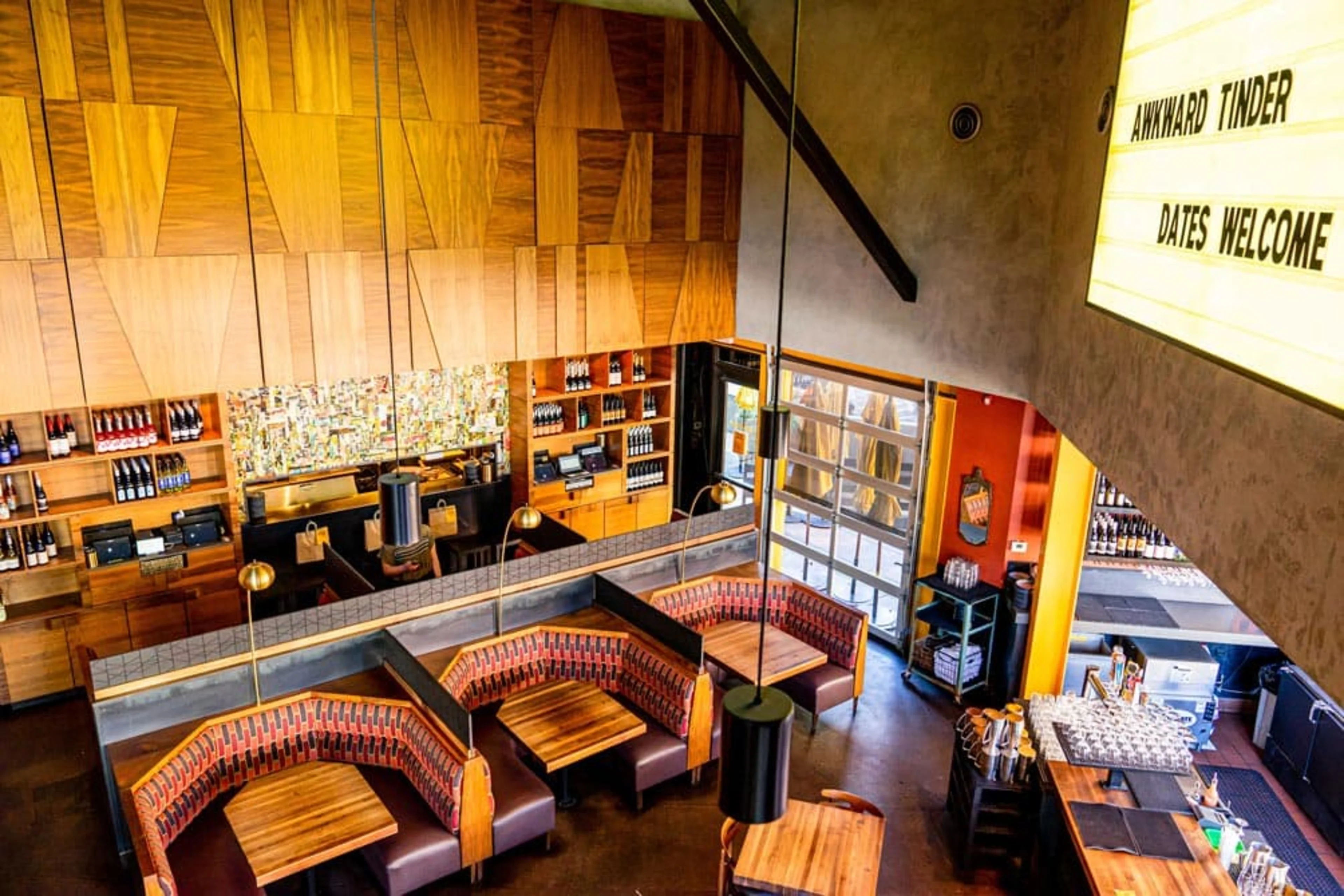 Downward view of an empty restaurant with large booths.