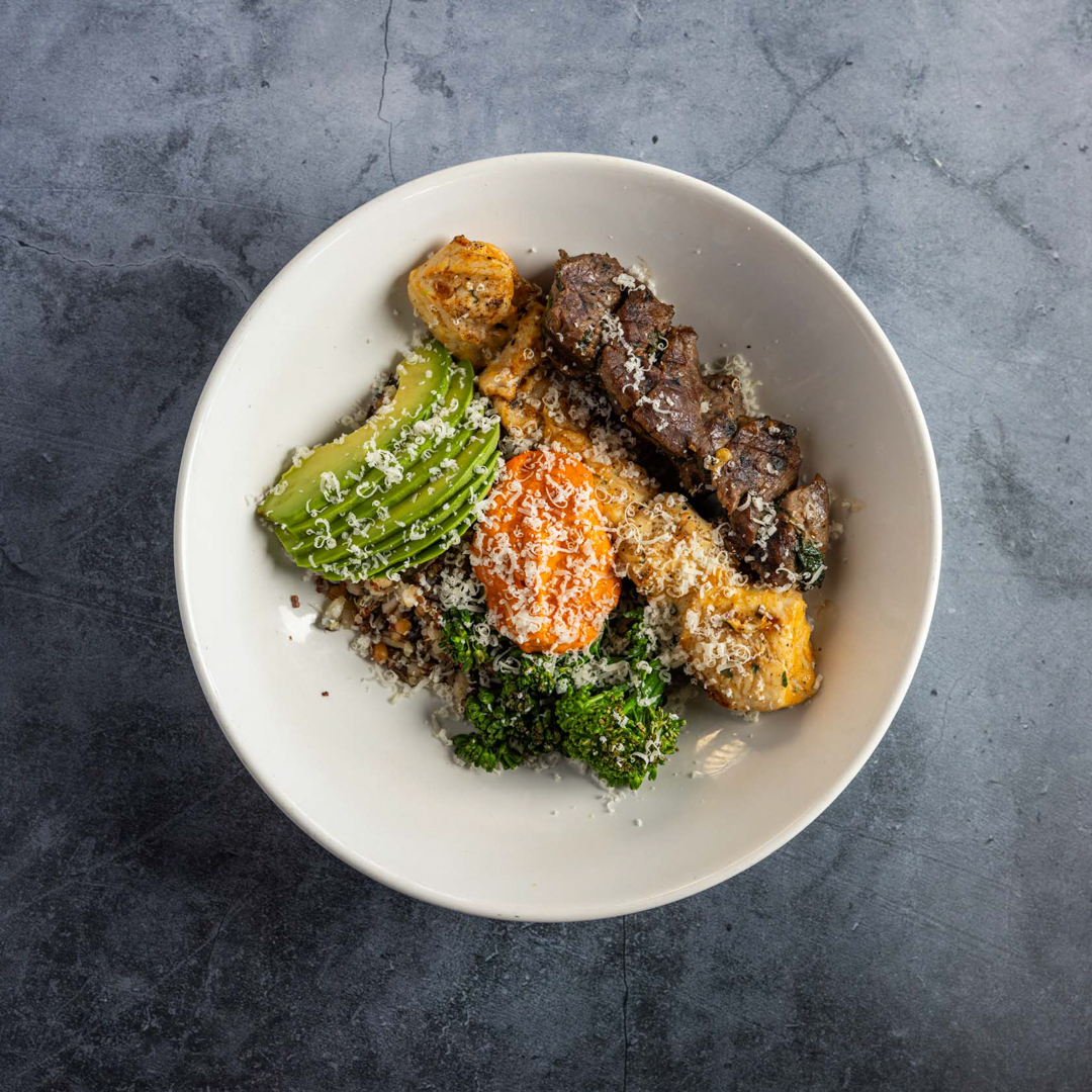 grilled skewer, boiled egg, broccolini, avocado, parmigiano reggiano, warm heritage grains, romesco, toasted hemp seed