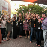A group of people holding up wine glasses. 
