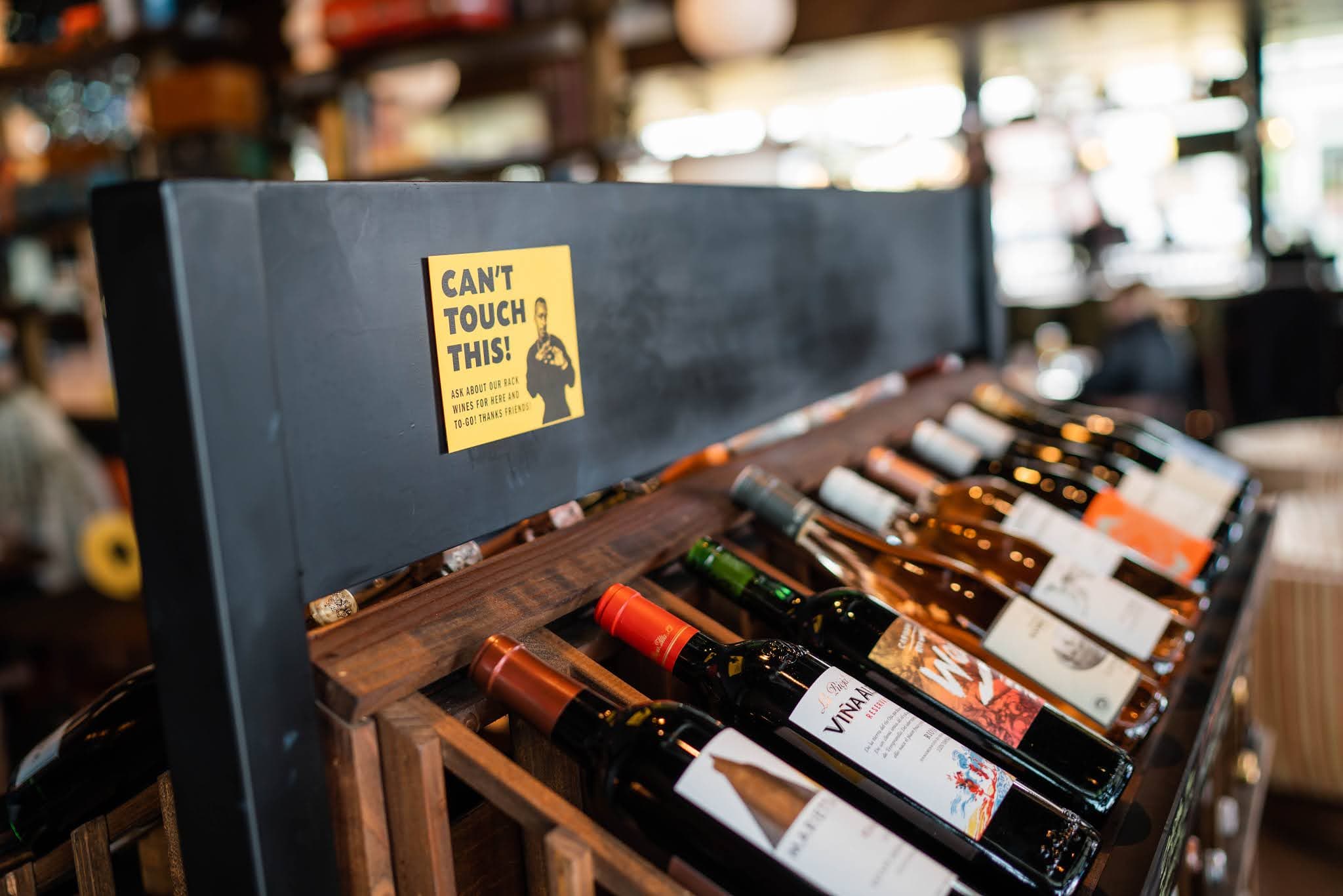 A wine rack with a sign that says "Can't touch this"