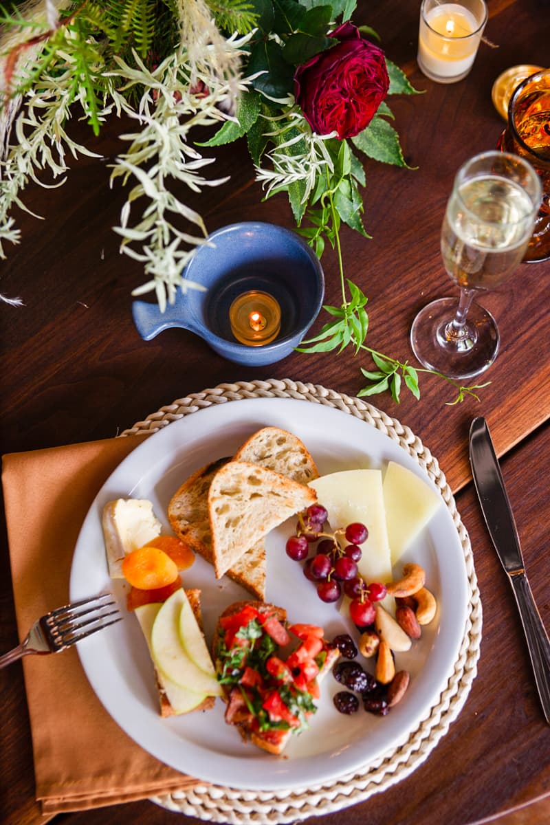 A plate full of cheese and fruit and nuts