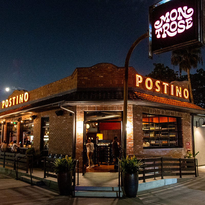 Photo of a Postino restaurant exterior at night