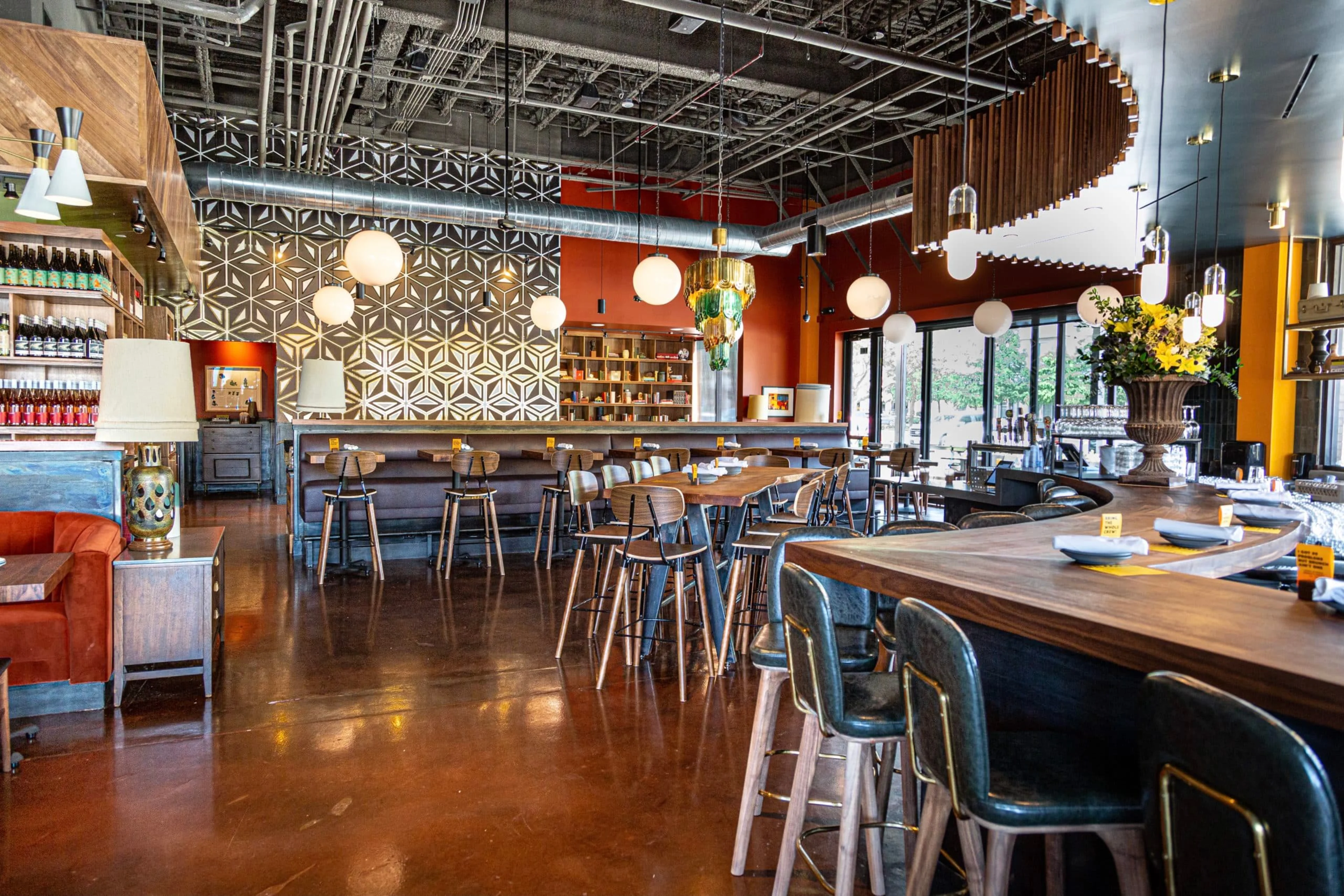 An empty restaurant with a wavy bar.