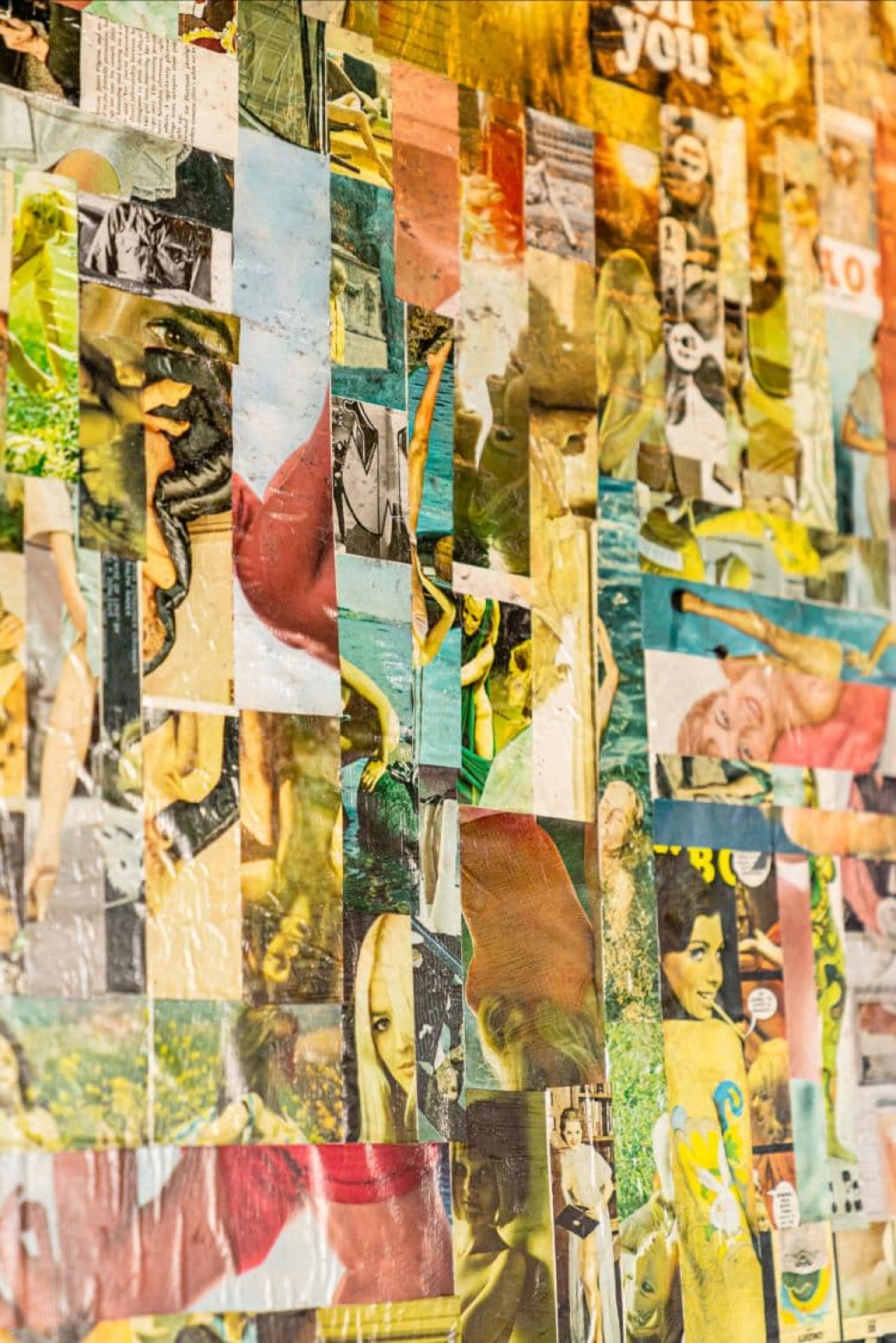 A wall with yellow, blue and red collage art.
