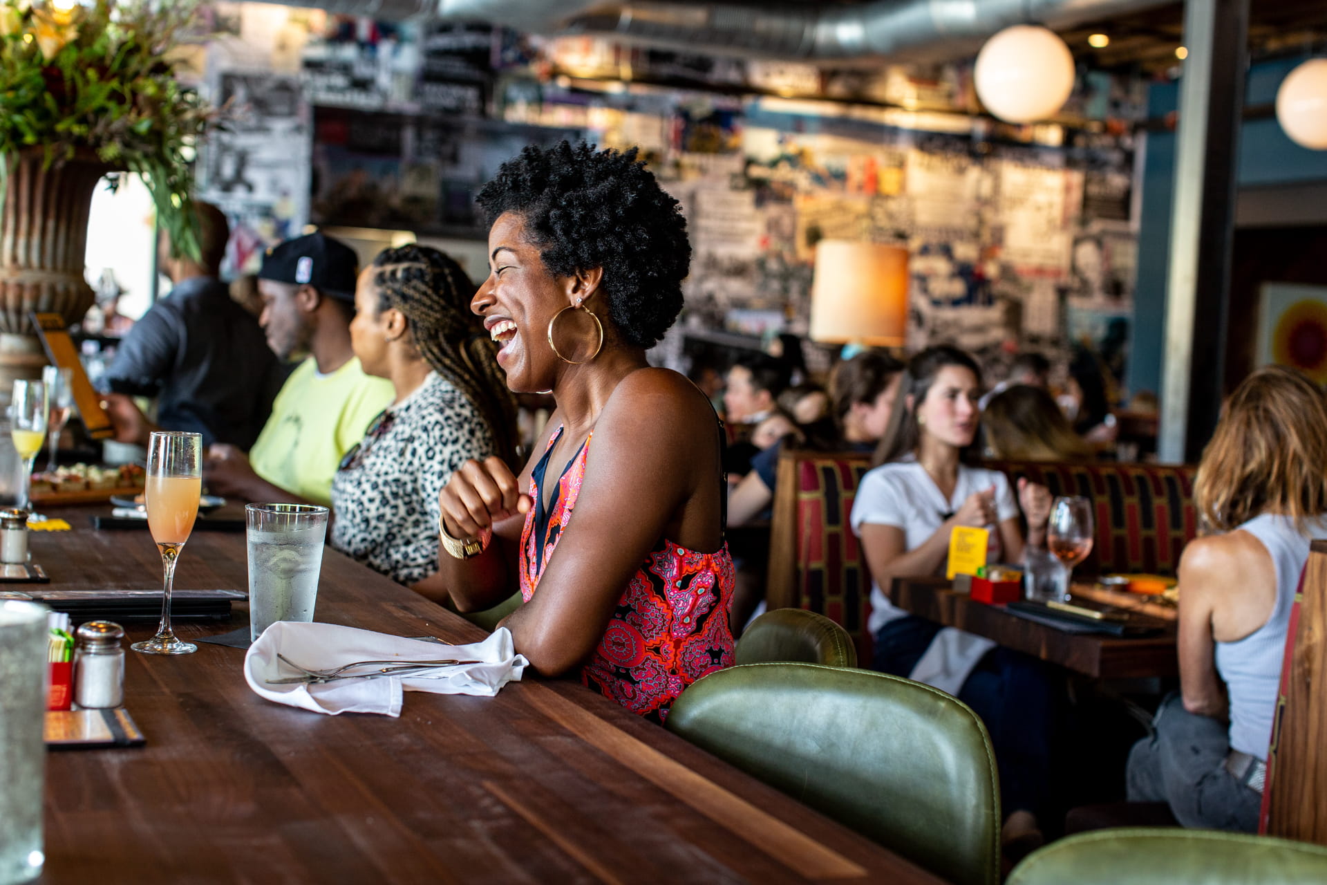 Photo of a woman laughing at a Postino bar