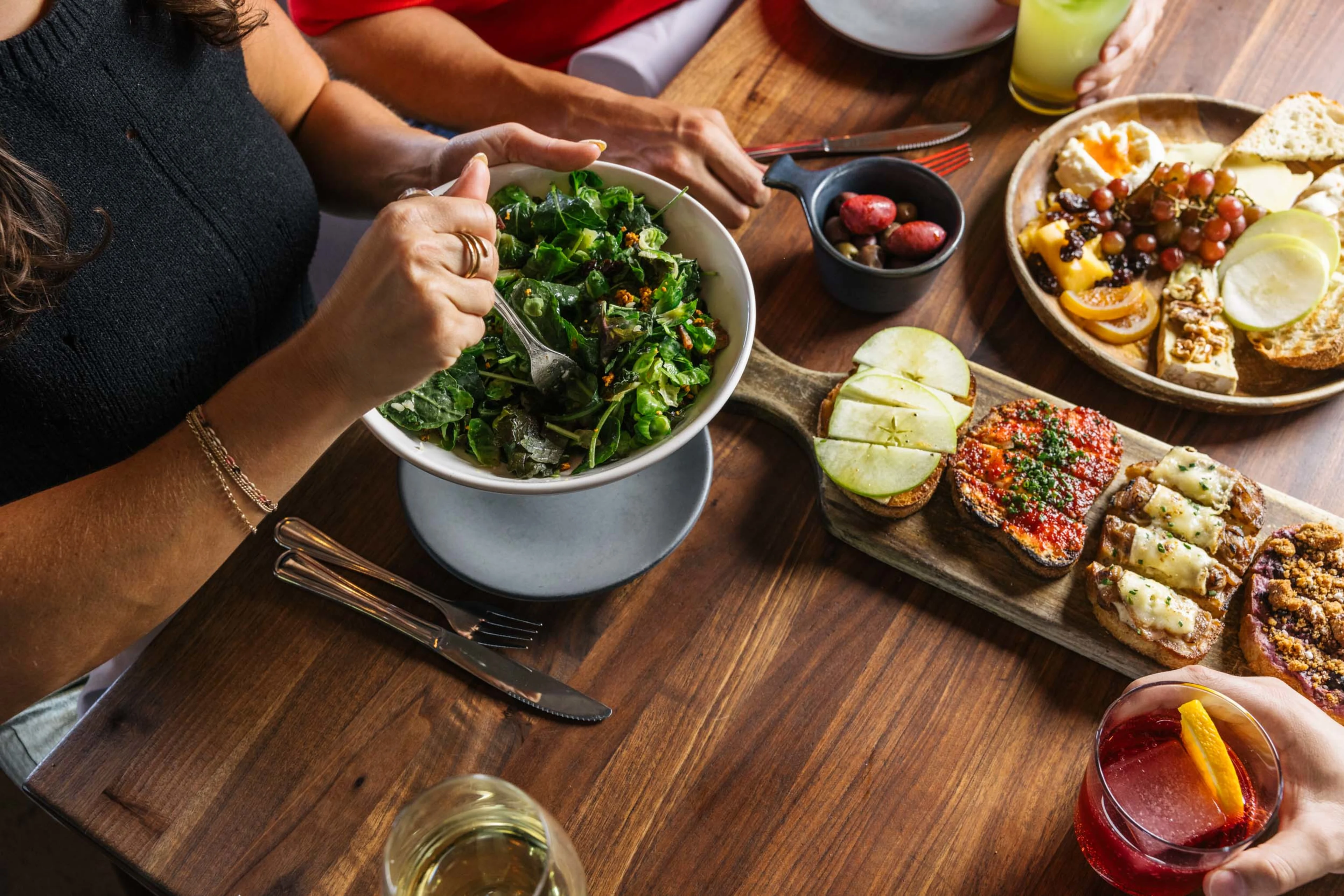 Close up of a person eating a Postino salad