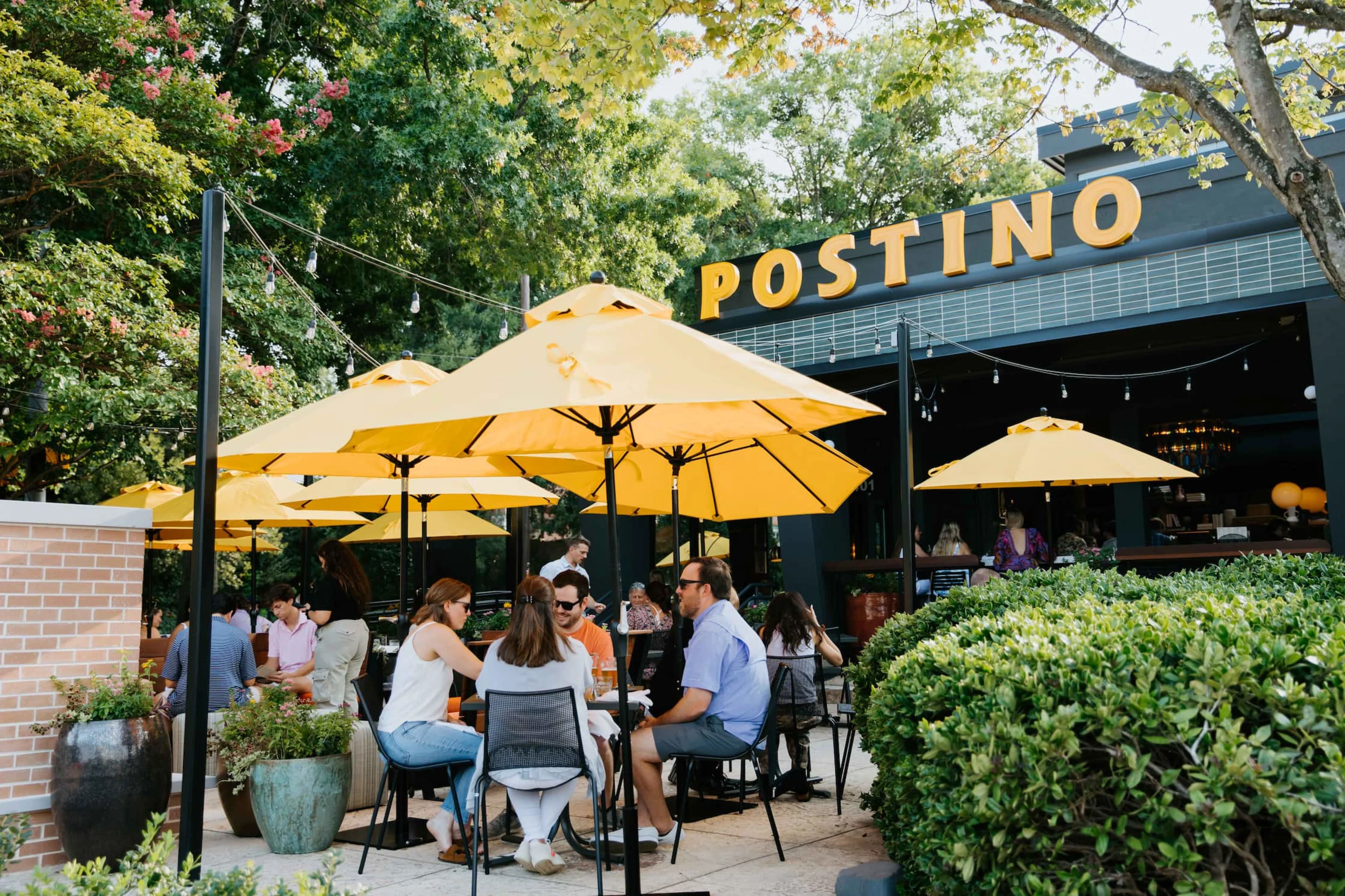 Postino Village District patio with guests