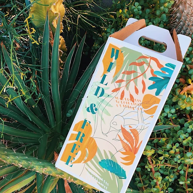 Wild and Free box laying on plants