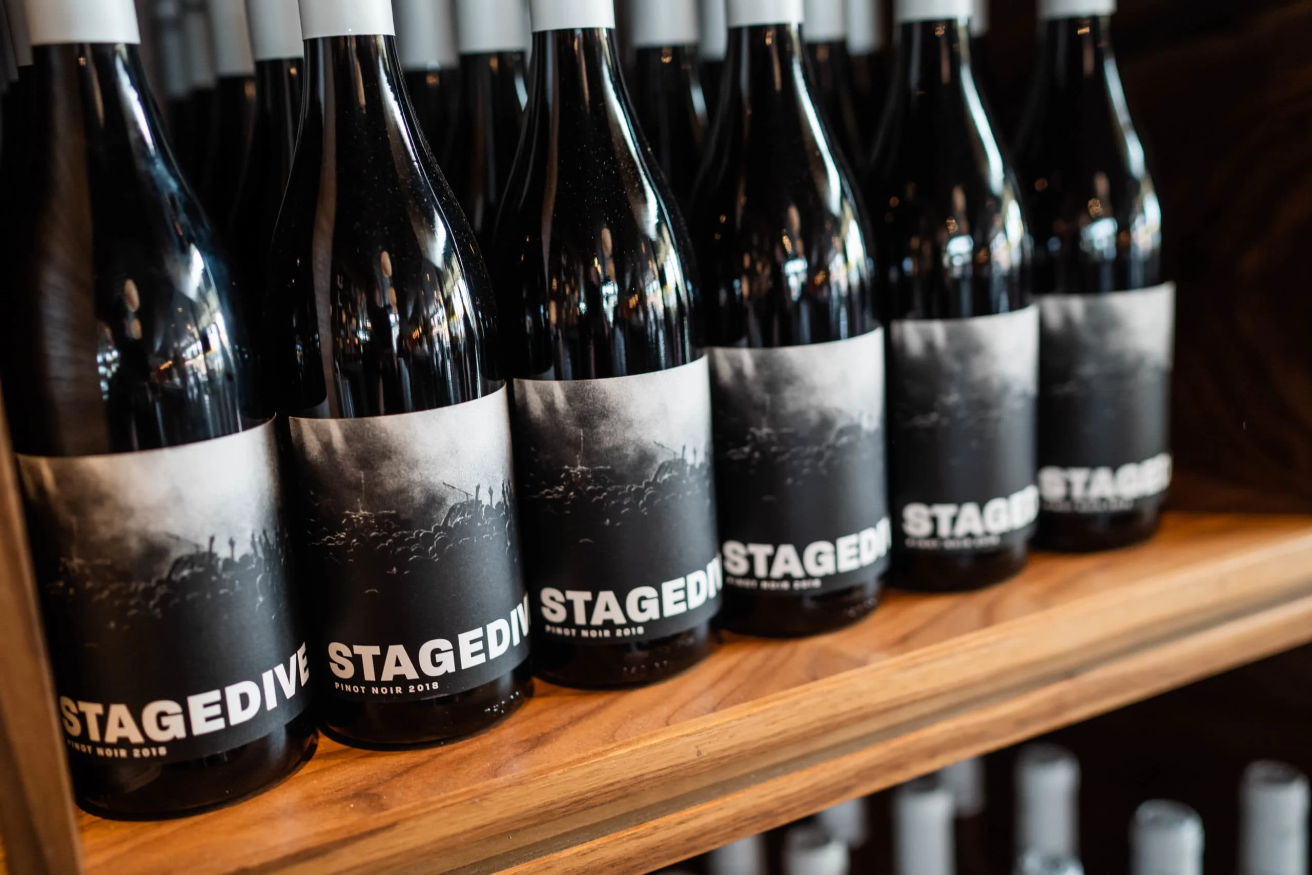 Black bottles of wine that say Stage Dive