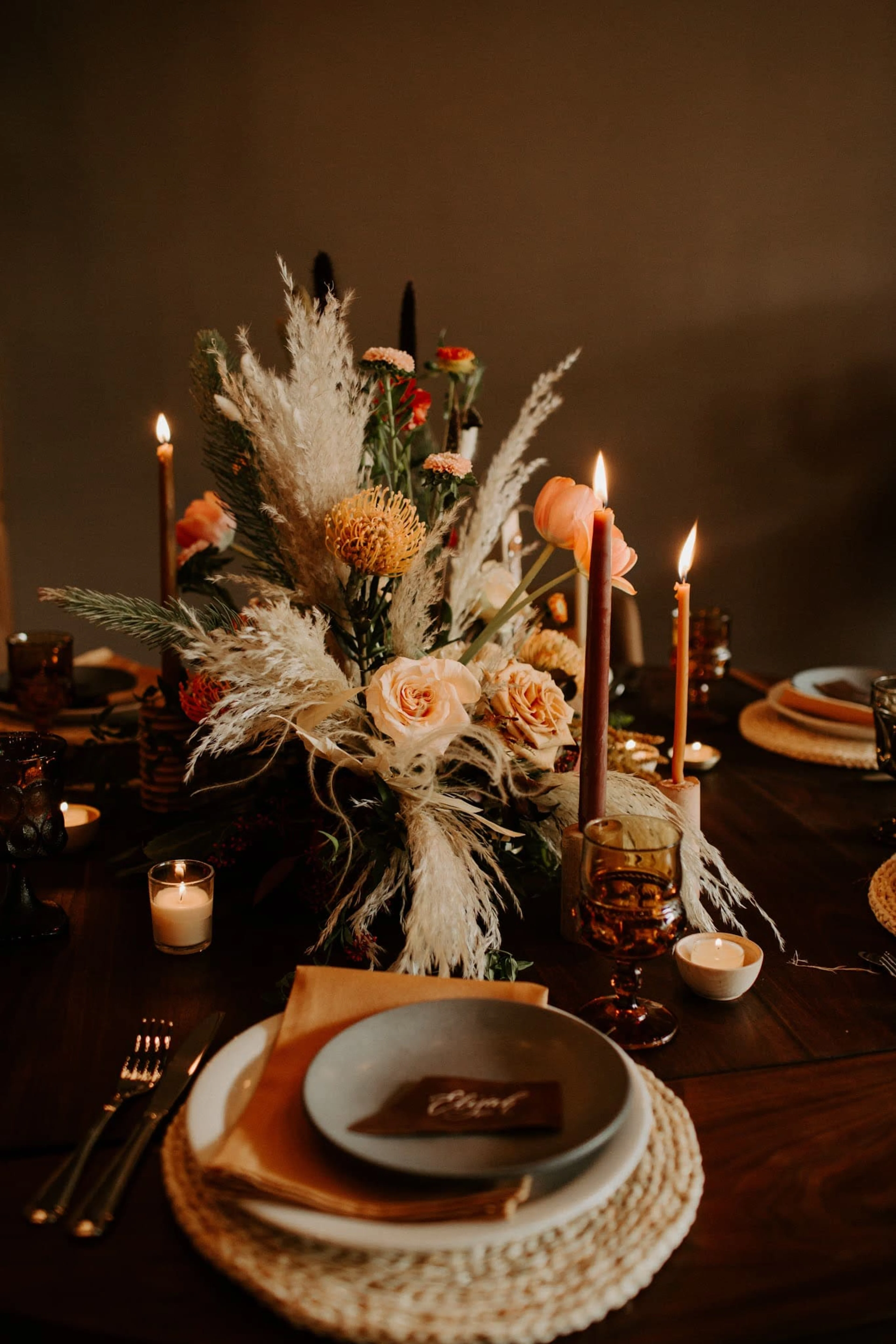 An elegant table setting with a flower arrangement and candles
