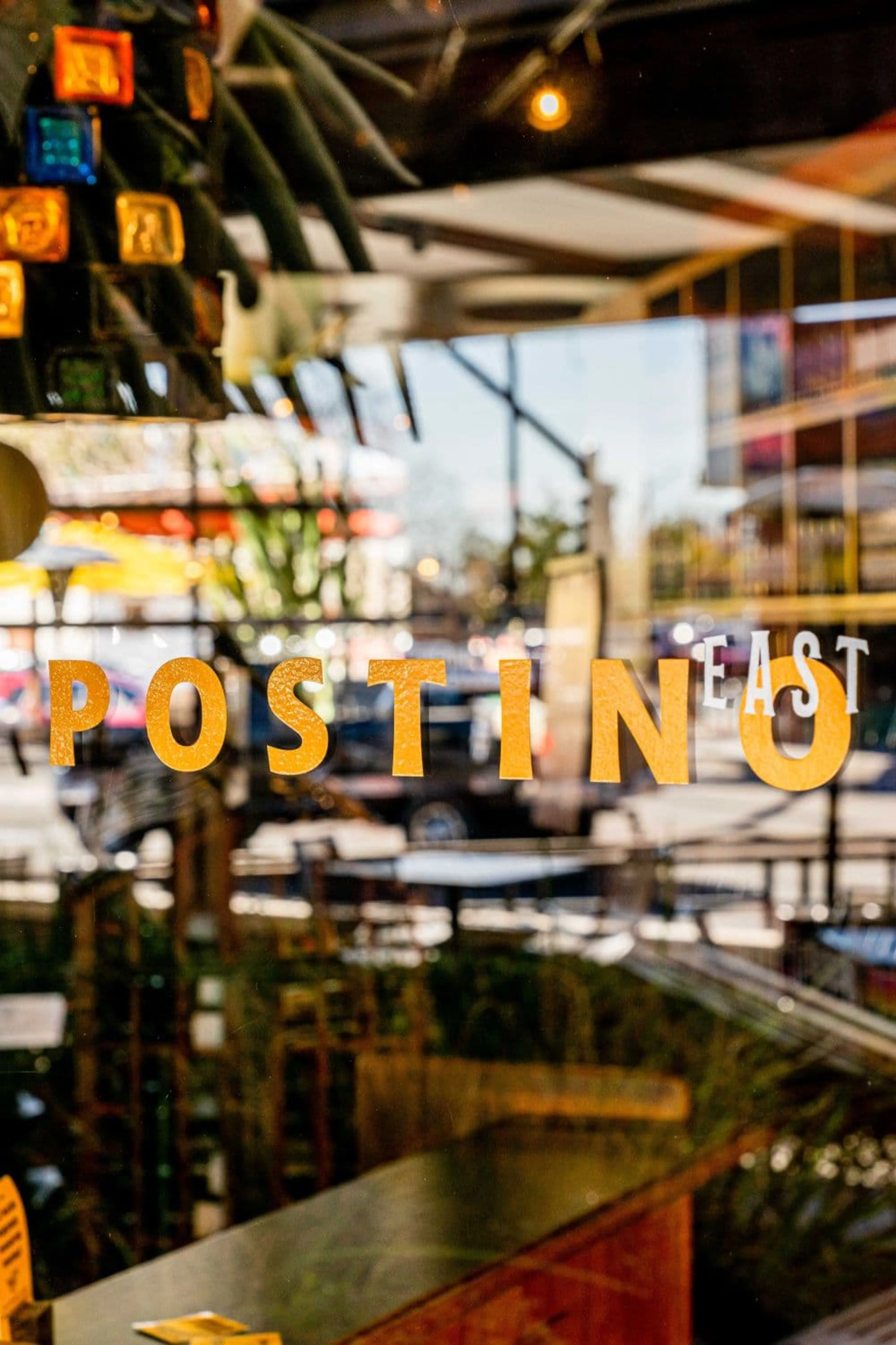 Glass window with Postino East logo