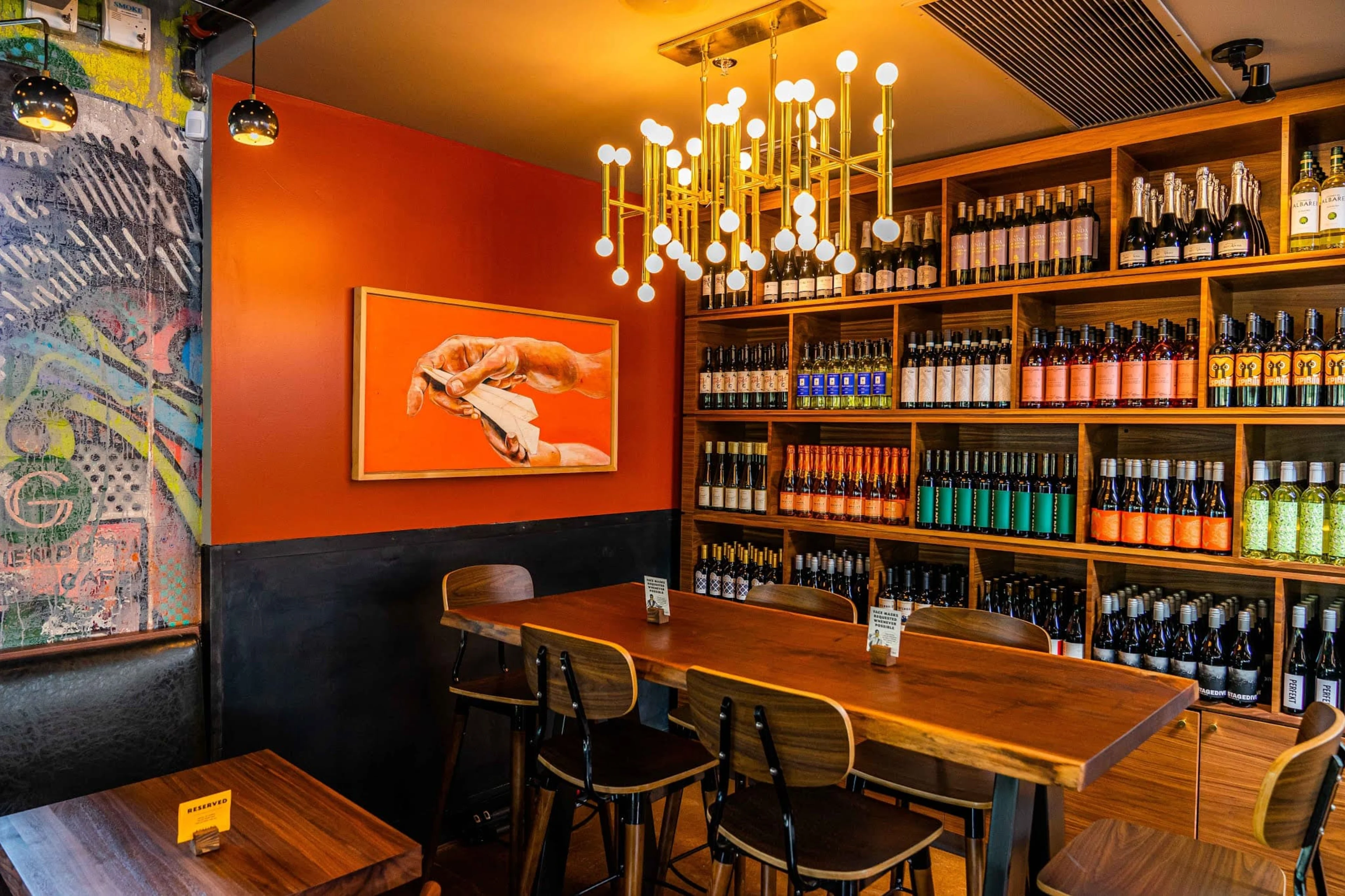 An empty wooden wine bar with a red wall.