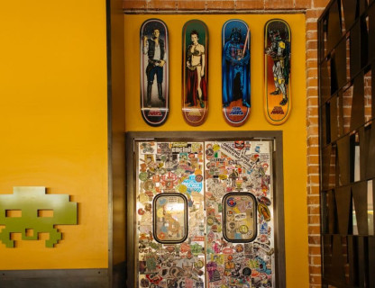 Yellow wall with colorful skateboards.