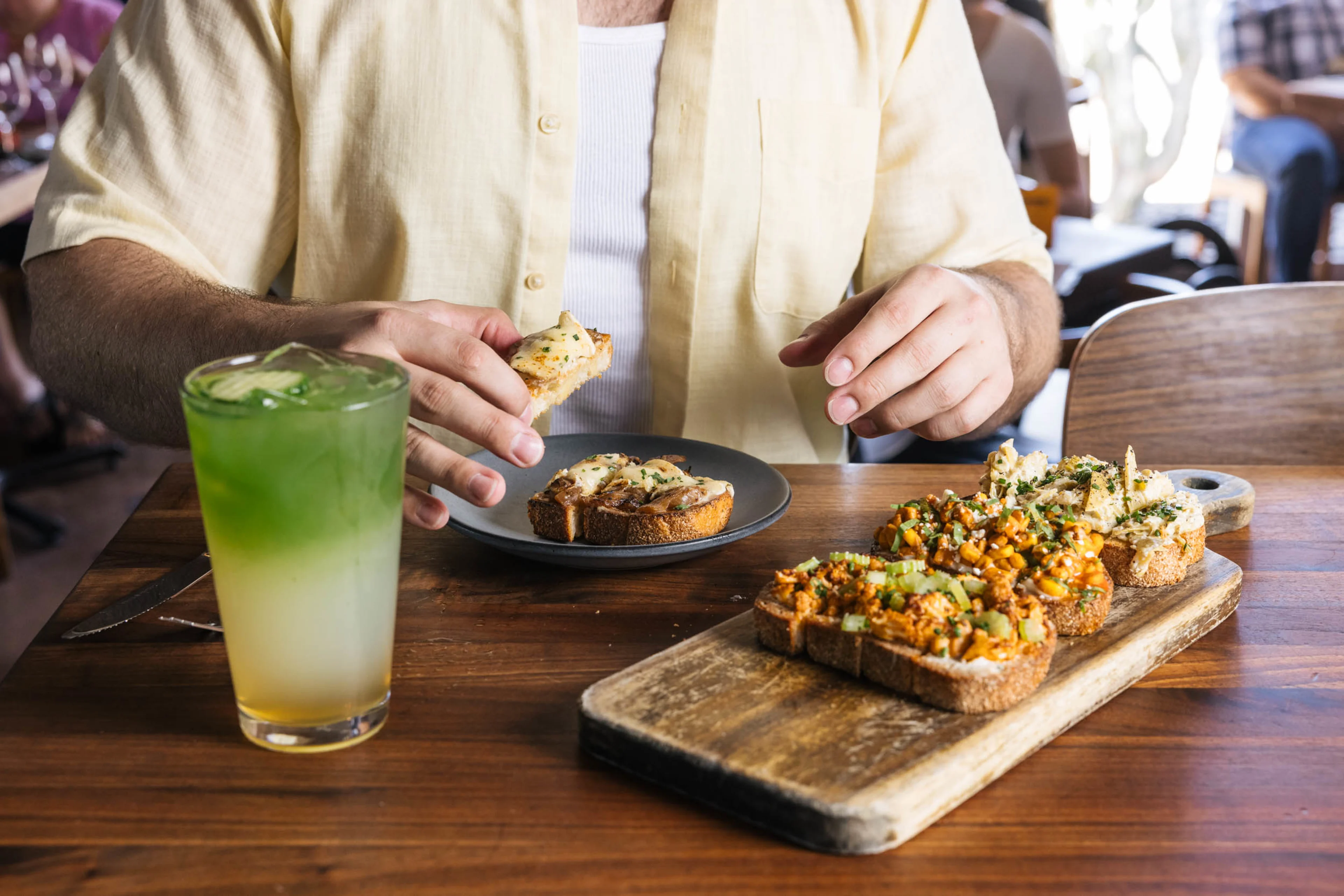 Close up of a person eating Postino bruschetta