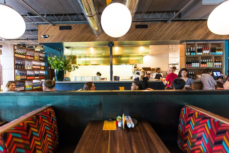A colorful booth next to a green wall.