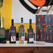 Wine bottles on a table with colorful boxes